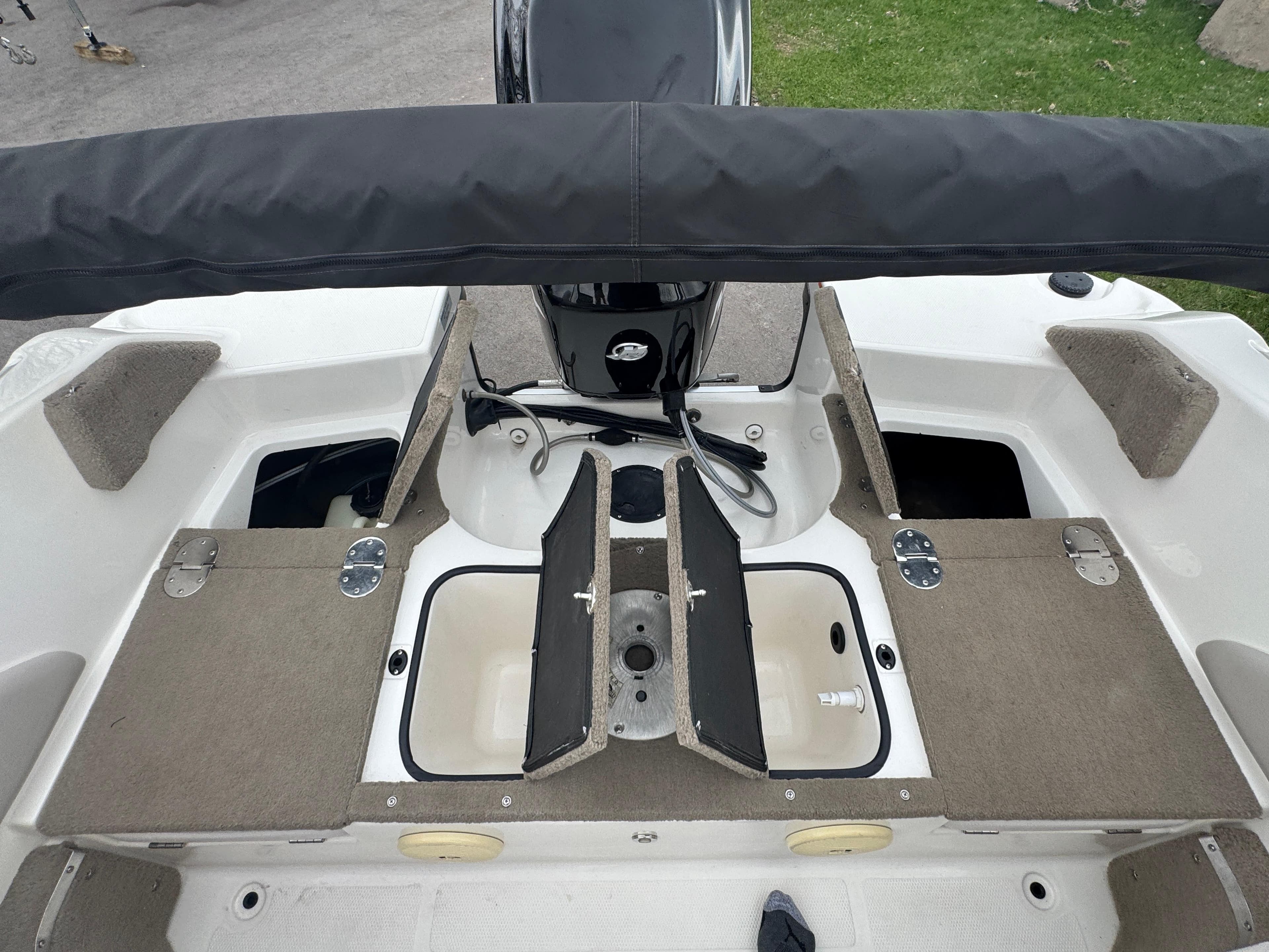 FinCraft 1850 boat interior, 2011 model, featuring storage compartments and seating area.