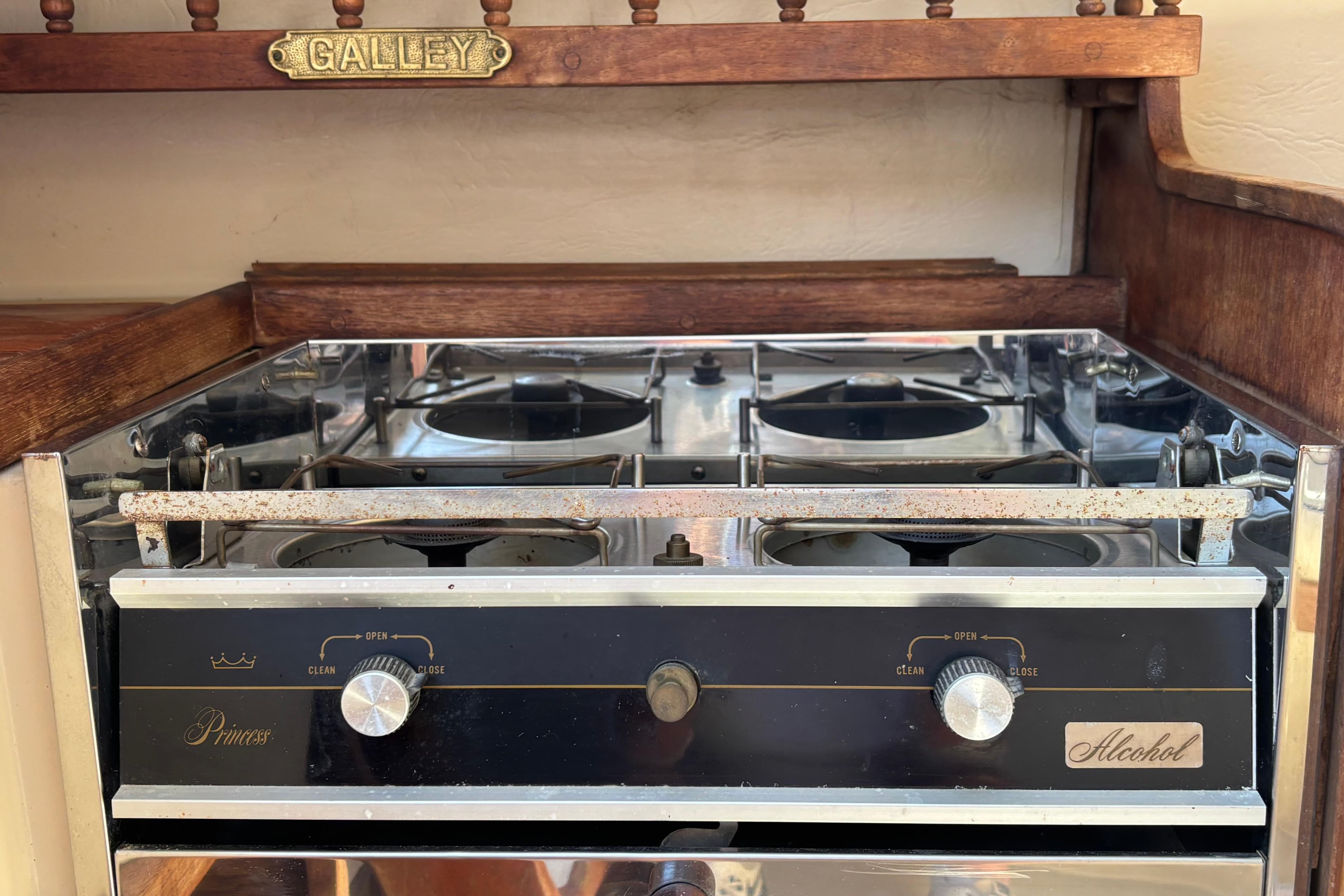 Vintage alcohol stove in 1983 Catalina 25 sailboat galley, featuring classic design elements.