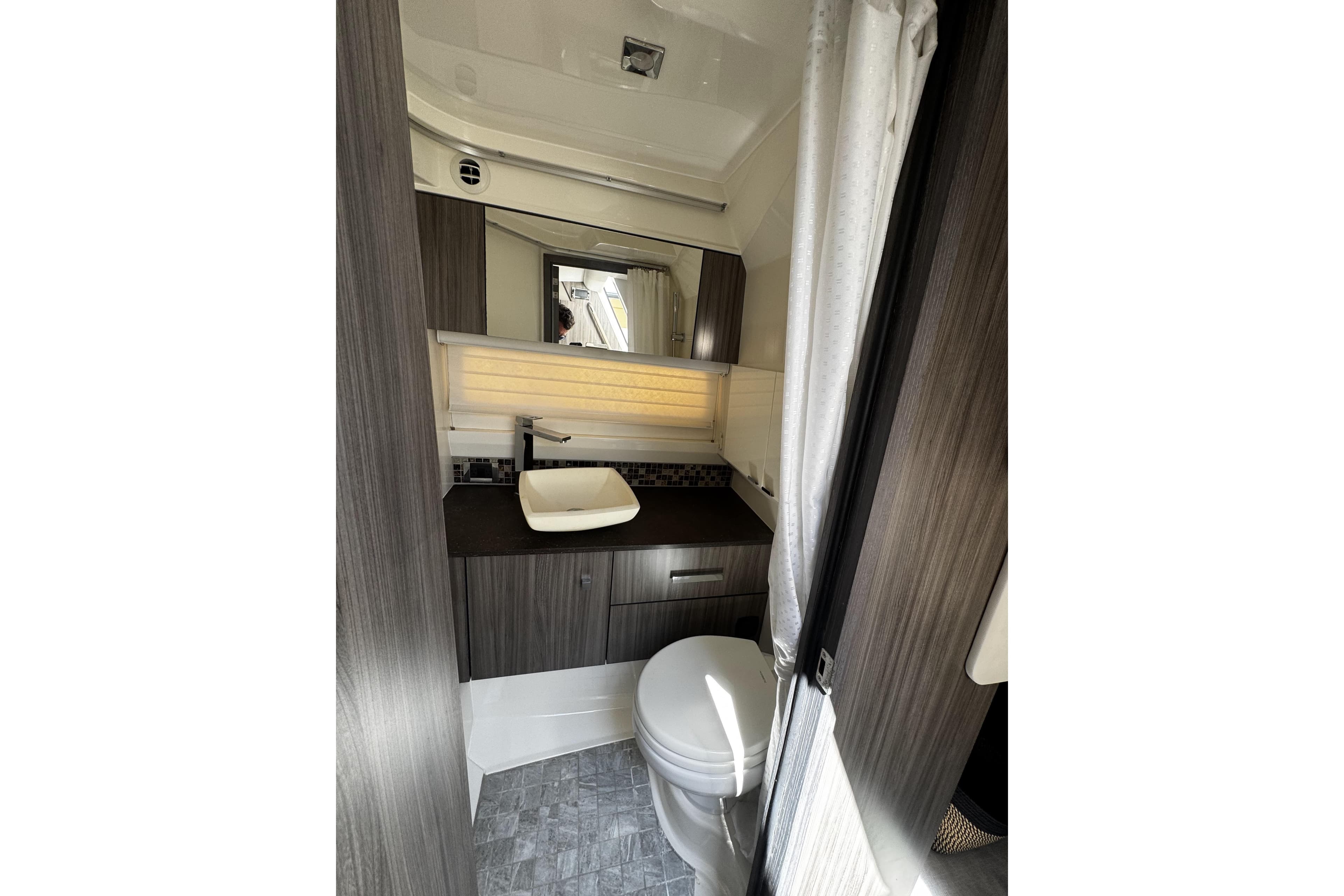 Luxurious bathroom interior of 2023 Sea Ray SLX 400 boat, featuring modern fixtures and elegant design.