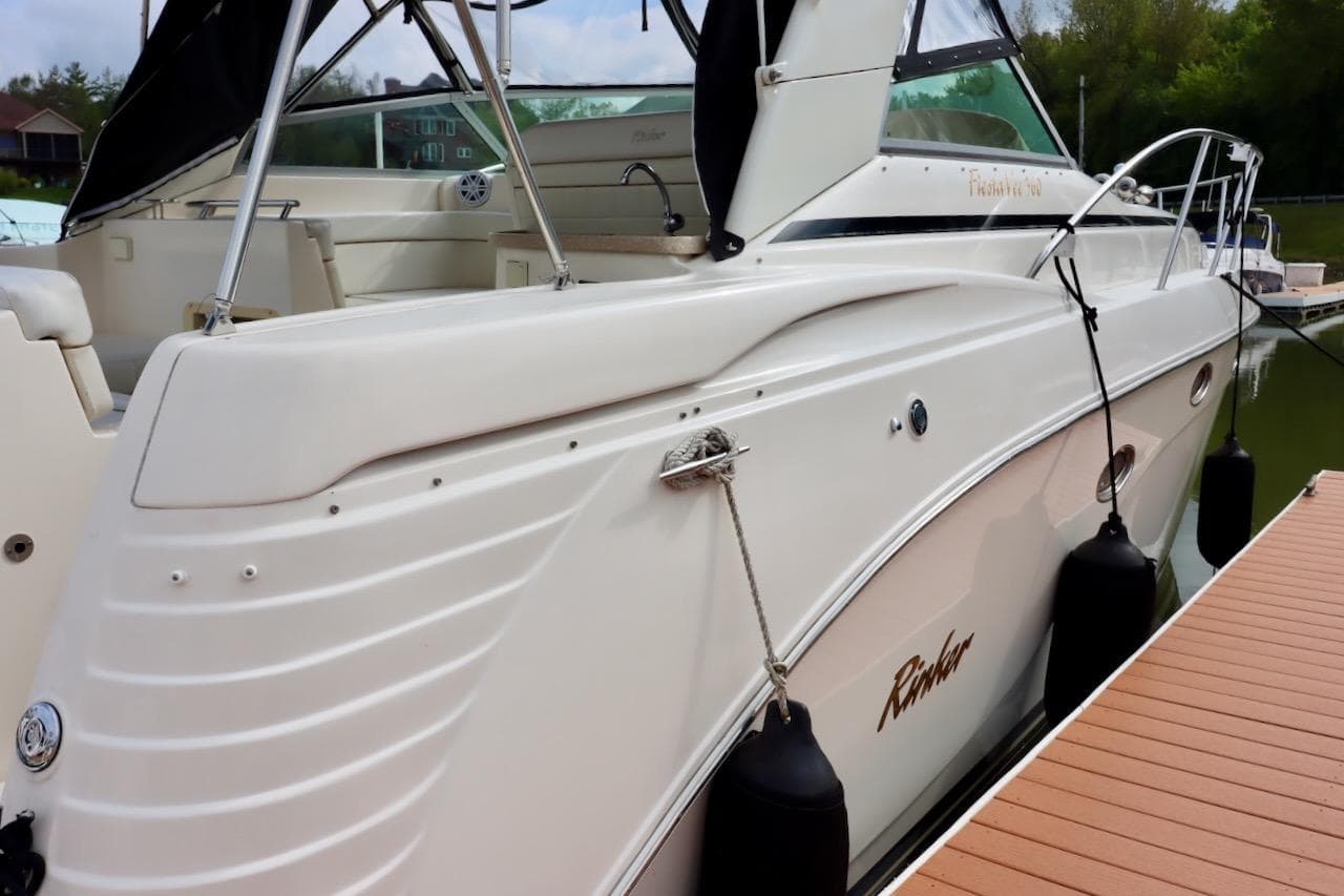 2006 Rinker 360 Express Cruiser docked, showcasing sleek design and spacious deck.