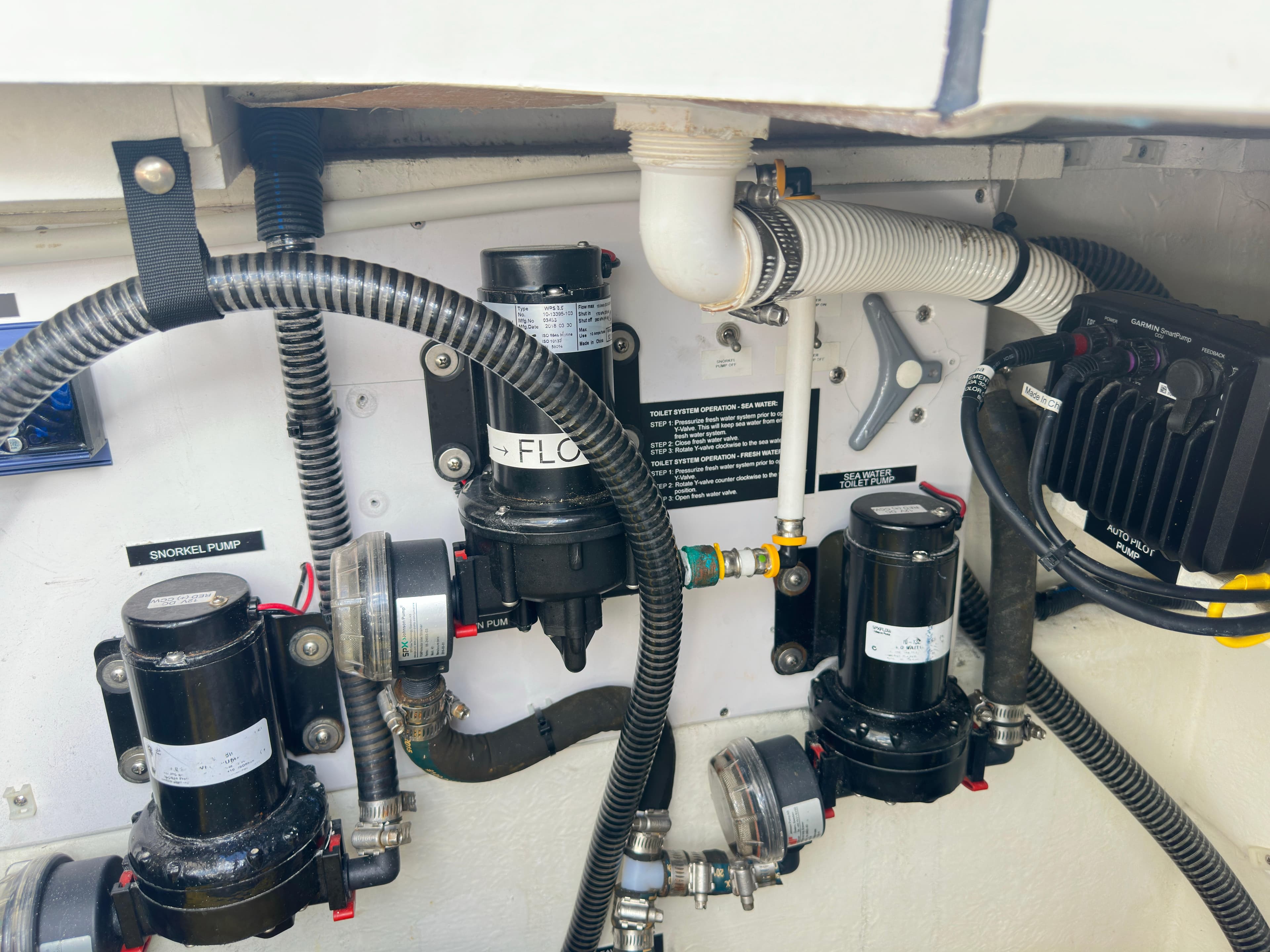 Engine compartment of a 2017 Aspen C120, showcasing pumps and wiring.