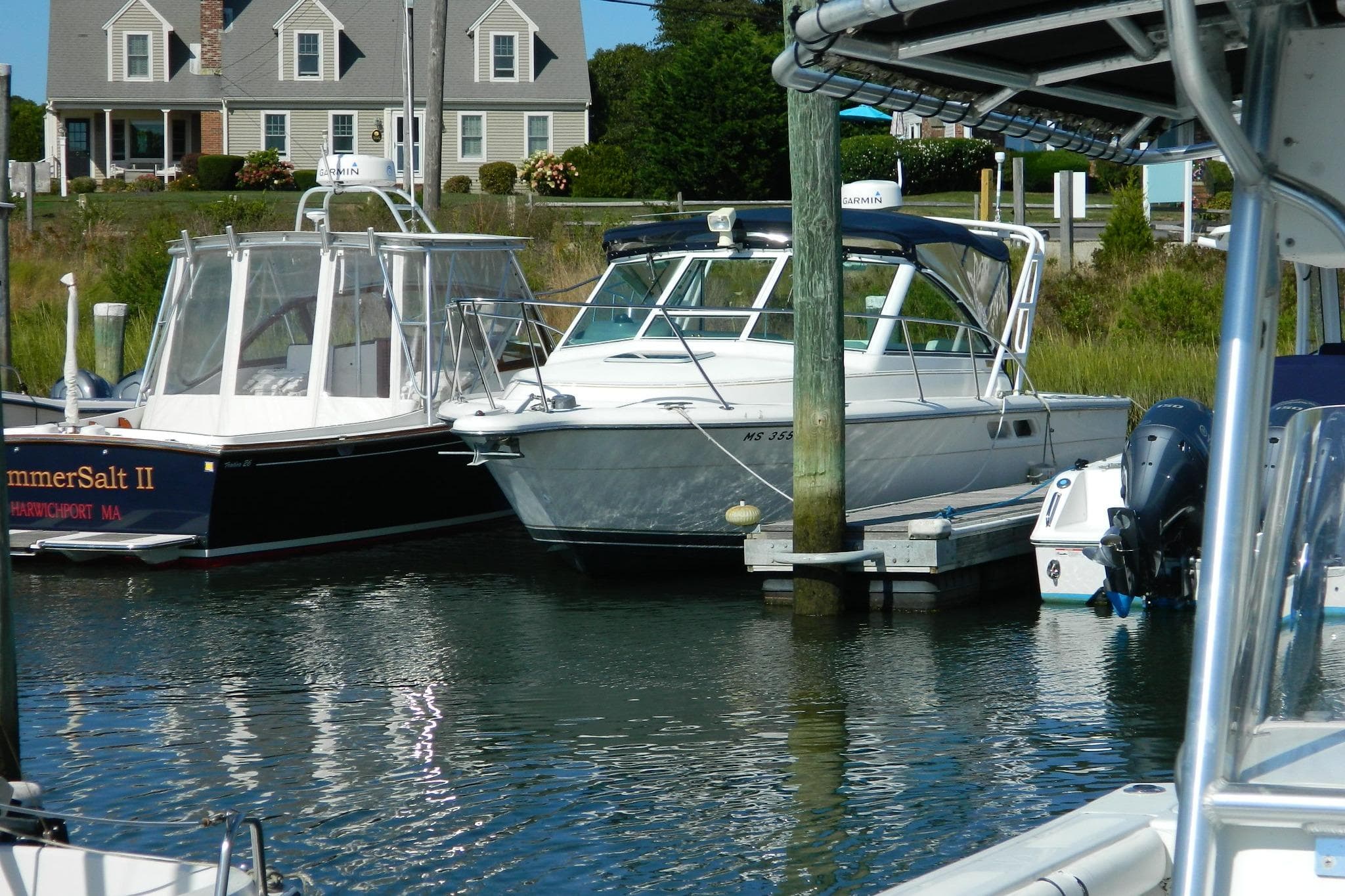 1999 Tiara Yachts 2900 Coronet docked at marina with neighboring boats.
