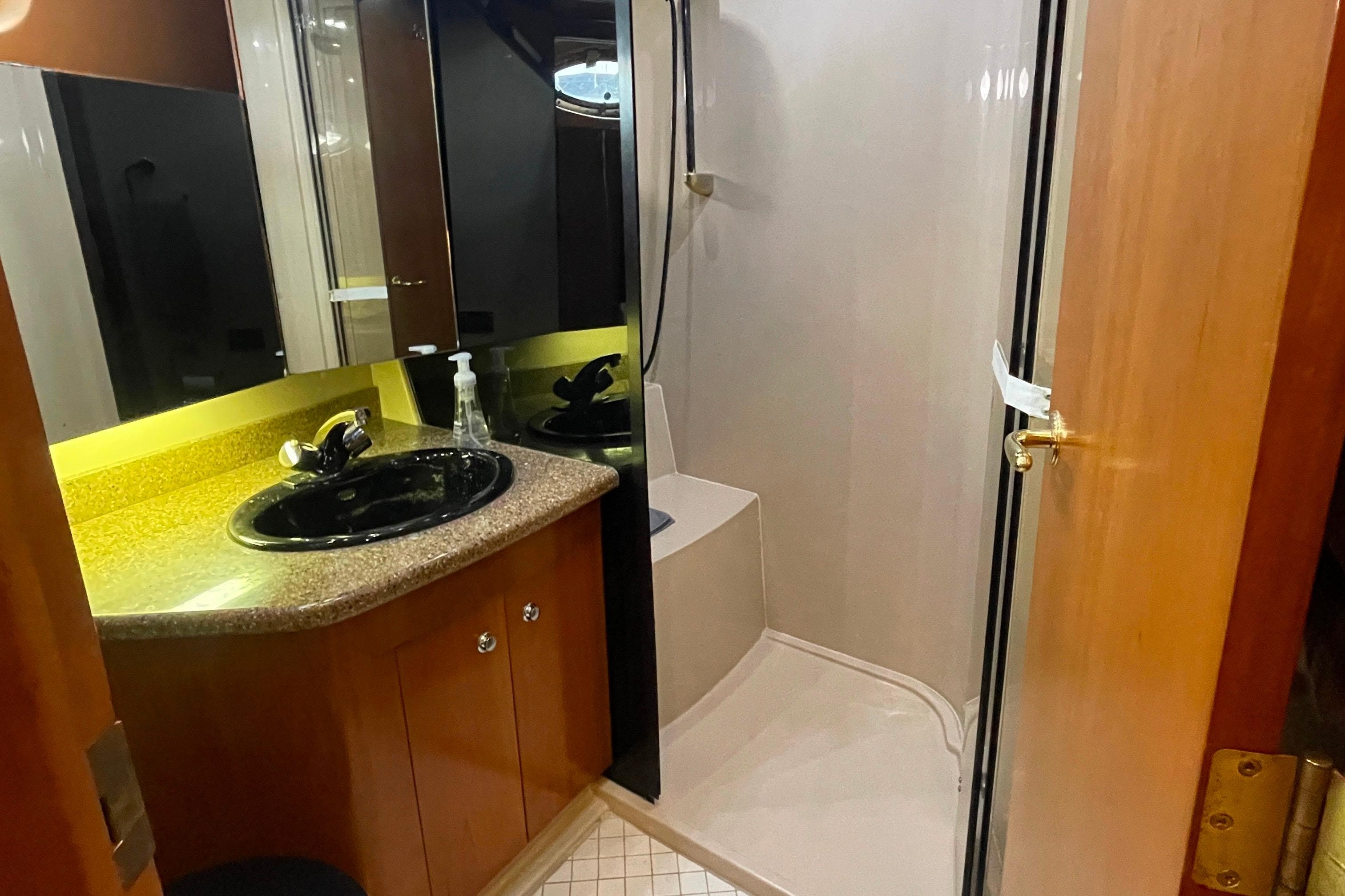 Bathroom interior of 2001 Cruisers Yachts 5000 Pilothouse with sink and shower.