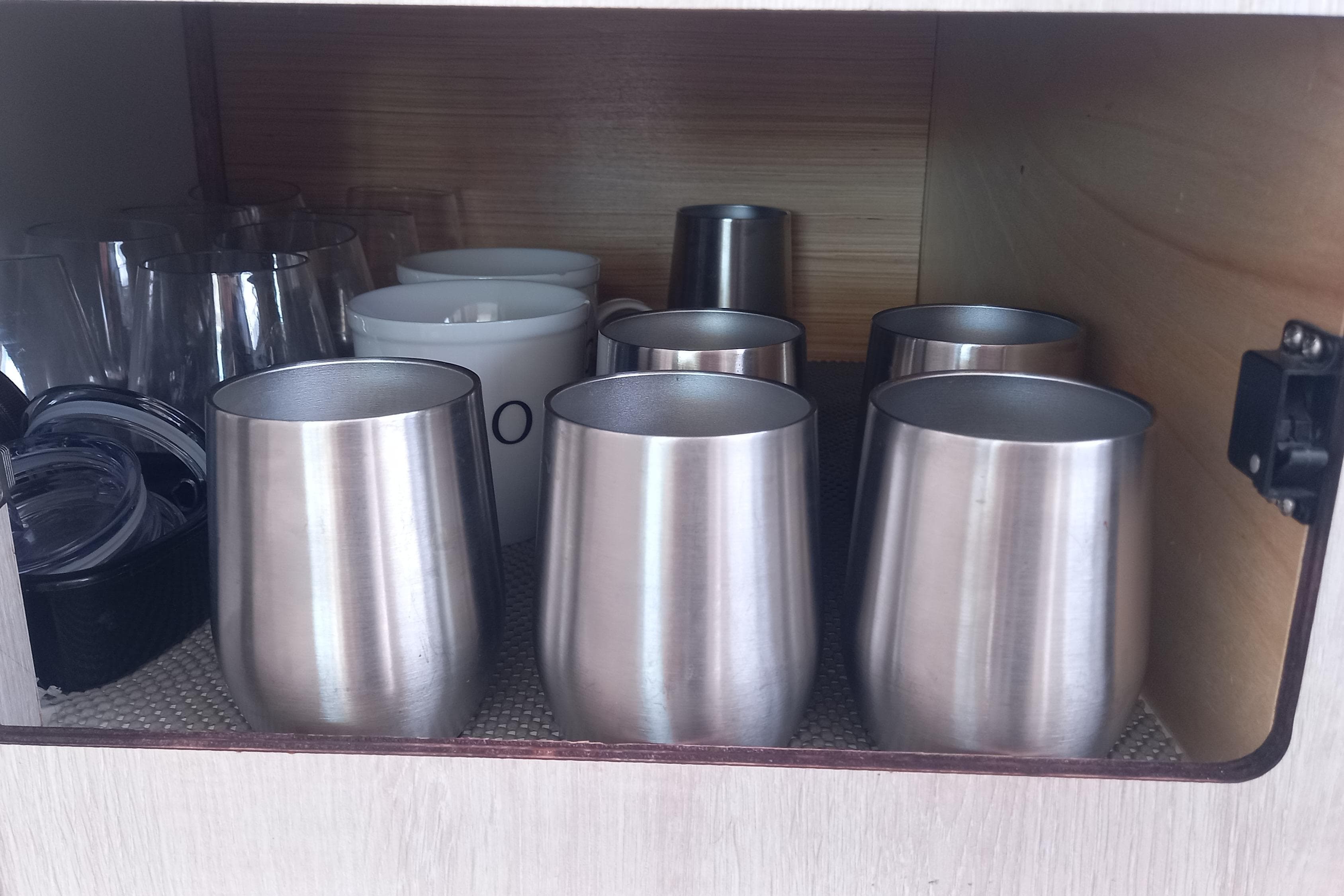 Stainless steel cups and glassware in Leopard 45 yacht cabinet, 2019 model.