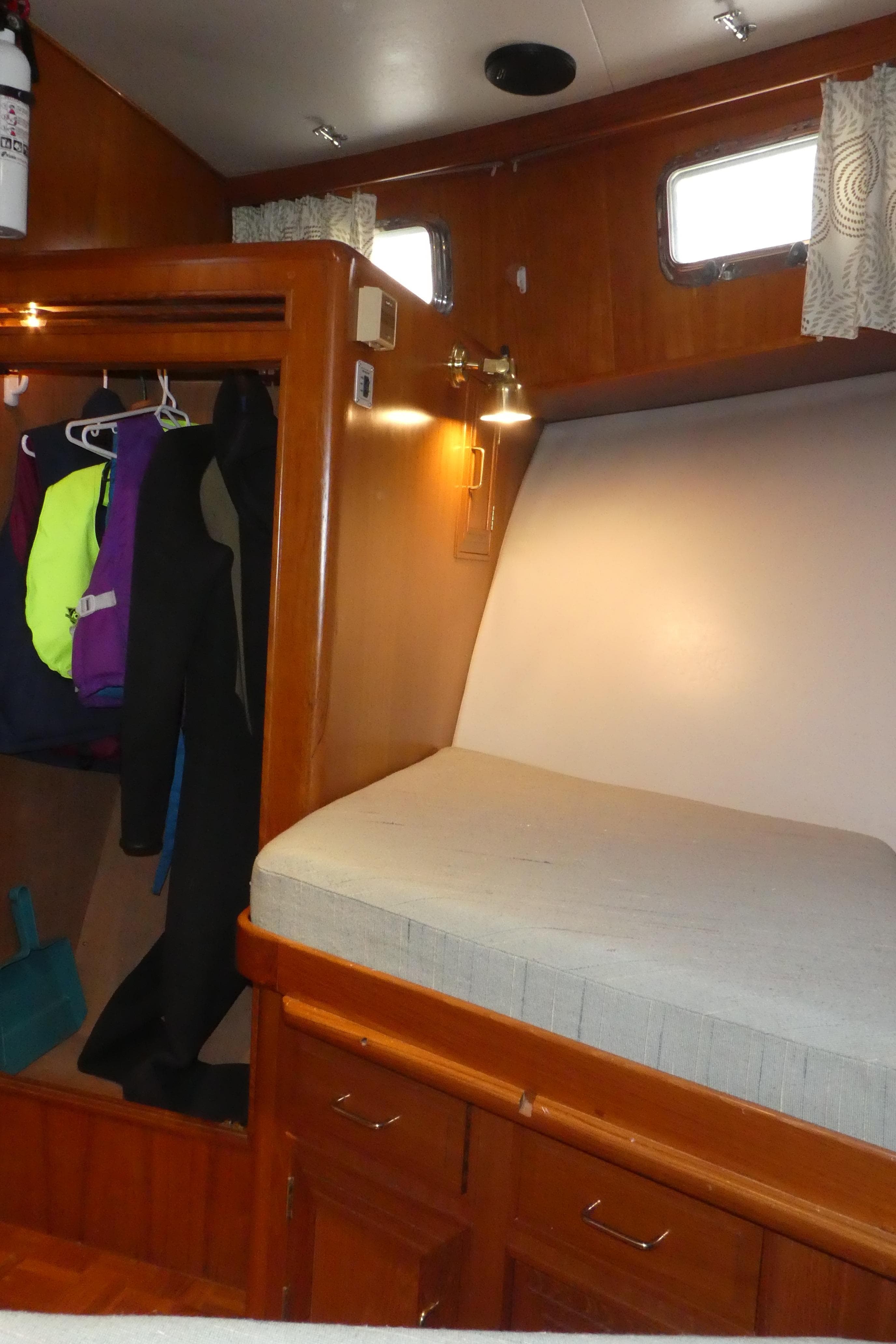 Cozy cabin interior of 1992 Ocean Alexander 456 Classicco yacht with wooden finishes.
