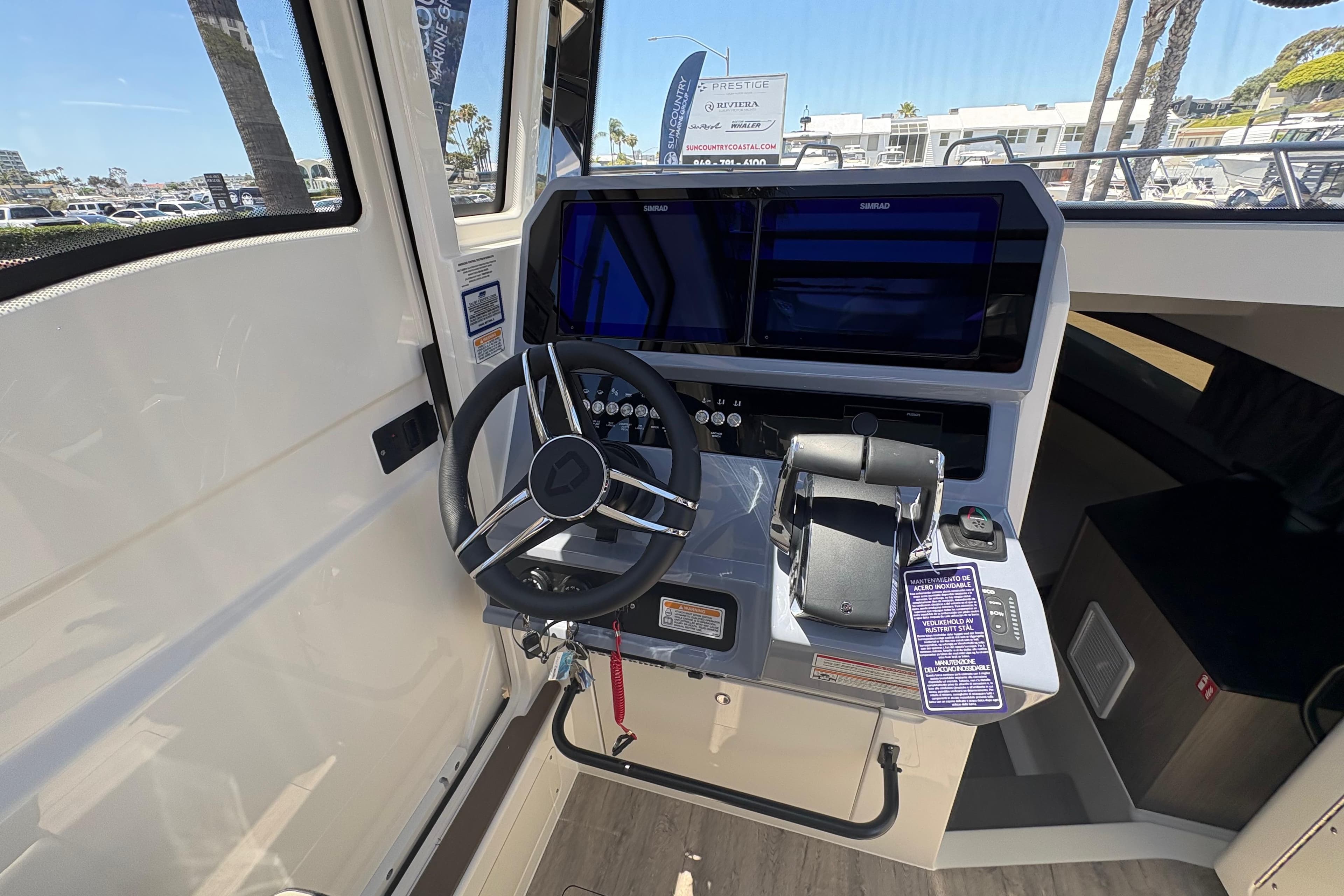 Interior cockpit of 2026 Navan C30 boat with steering wheel and control panel.