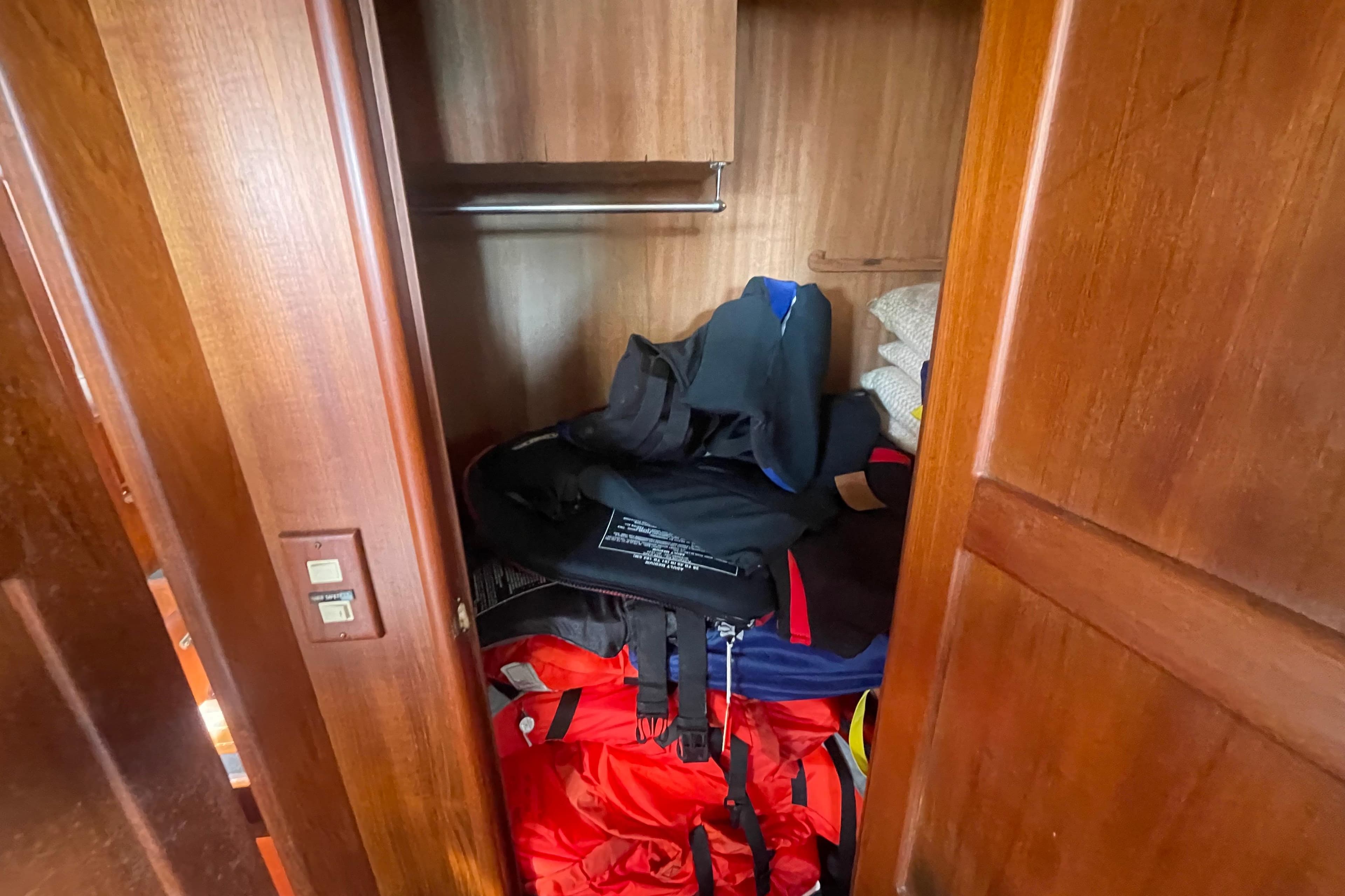 Wooden closet in 1986 Tung Hwa aft cabin, storing life jackets and pillows.