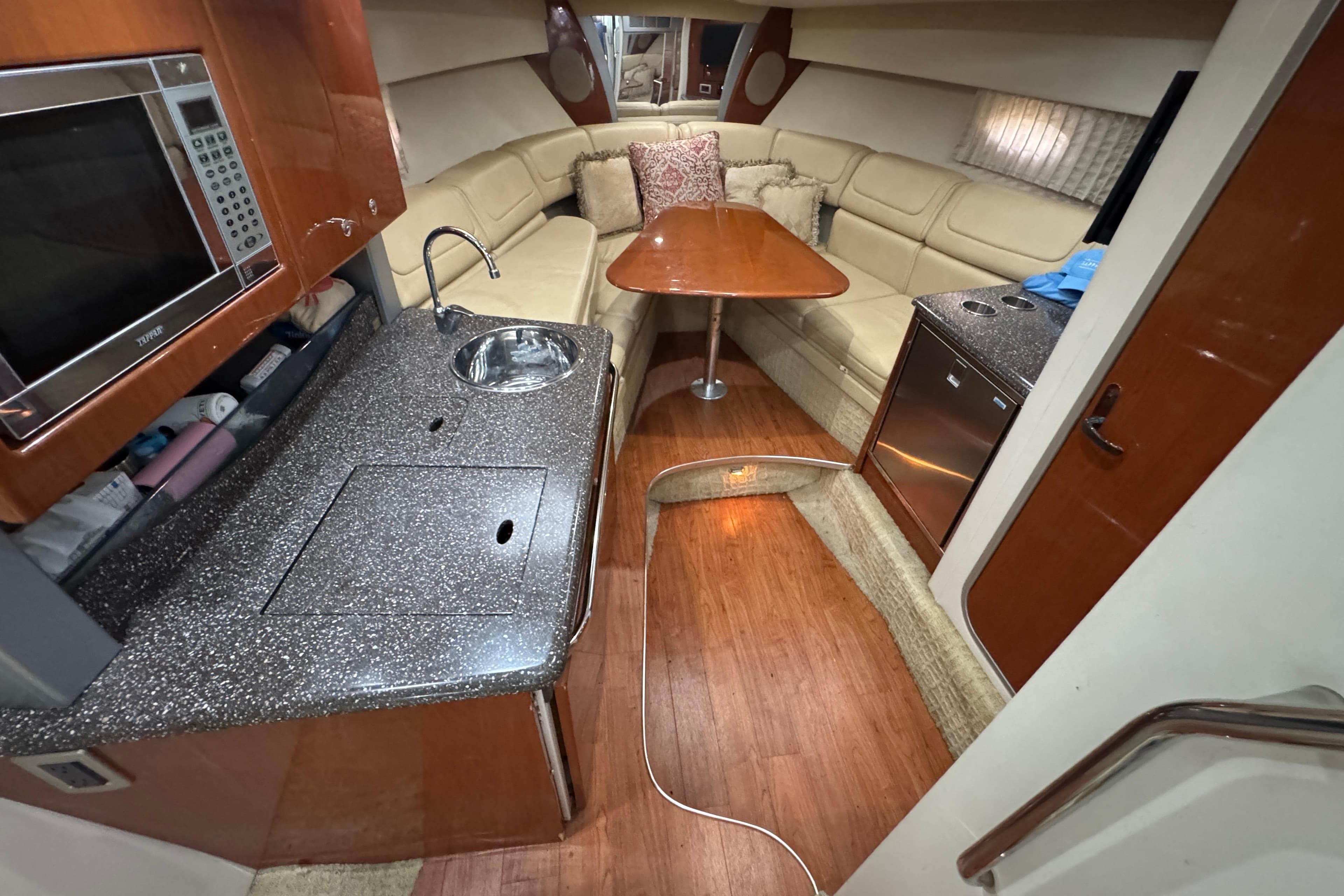 Interior of a 2008 Formula 350 Sun Sport boat with kitchen and seating area.