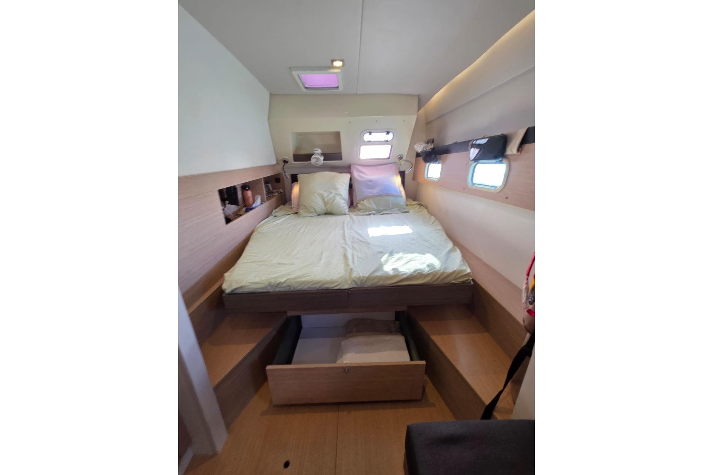 Cozy cabin interior of 2016 Bali 4.5 yacht with bed and storage drawers.