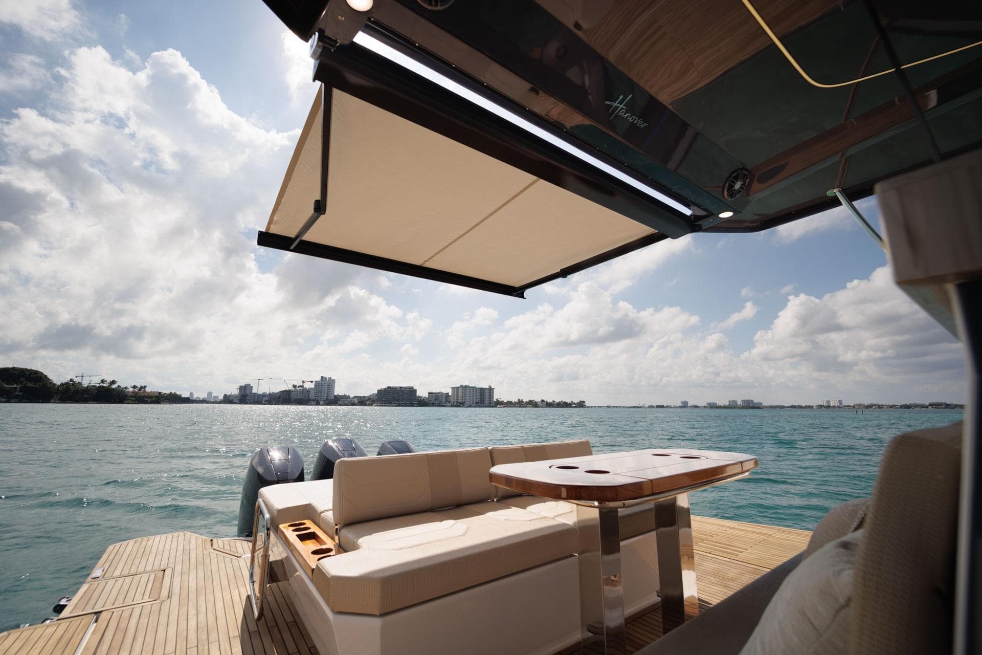 Luxurious Hanover 447 yacht deck with seating, awning, and ocean view, 2026 model.