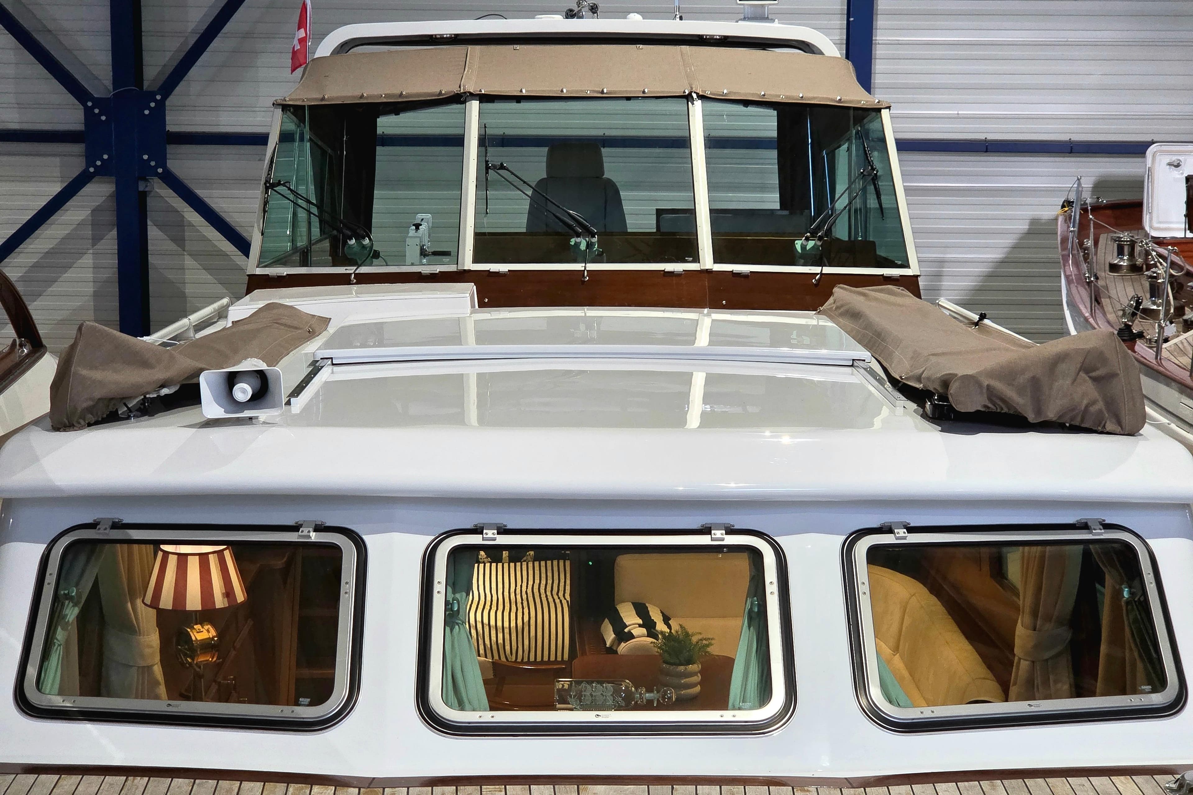 Super Van Craft 14.95 yacht, 1999 model, showcasing elegant interior through windows.
