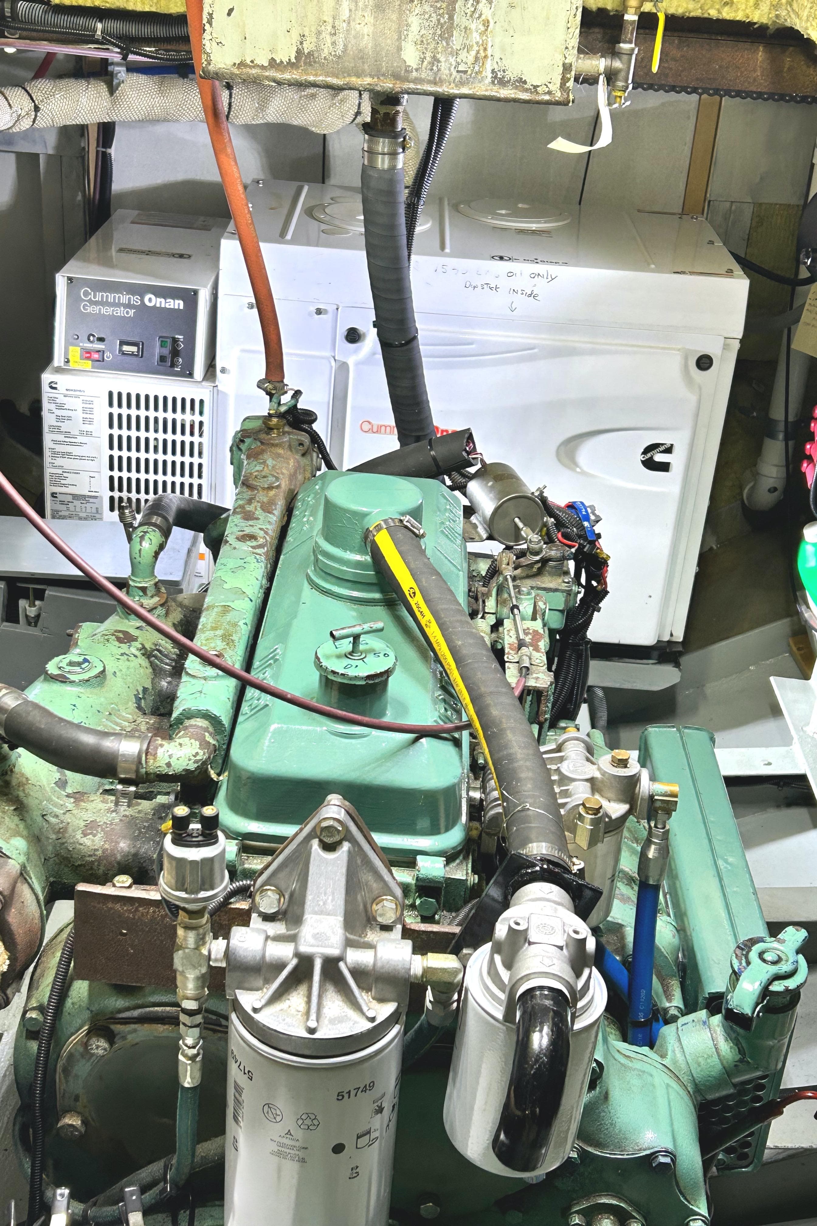 Engine room of a 1993 Custom Steel Trawler with Cummins Onan generator.