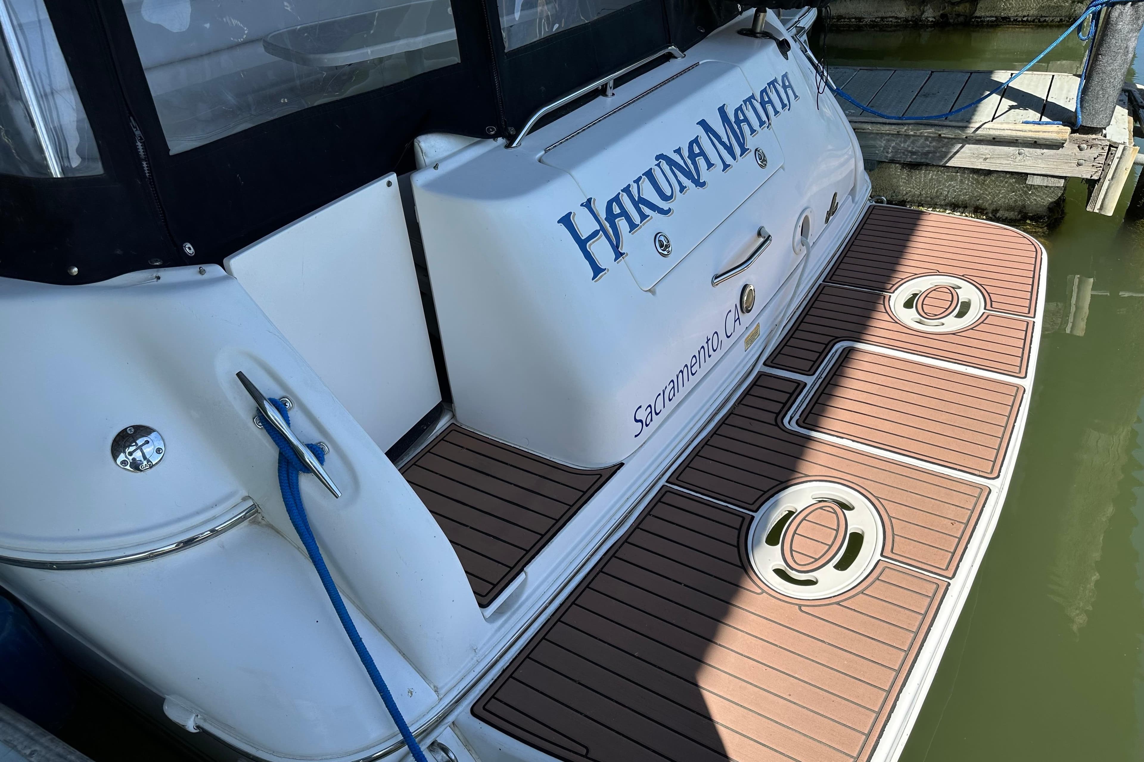 Sea Ray Sundancer 310 boat, 2000 model, docked with "Hakuna Matata" name, Sacramento, CA.