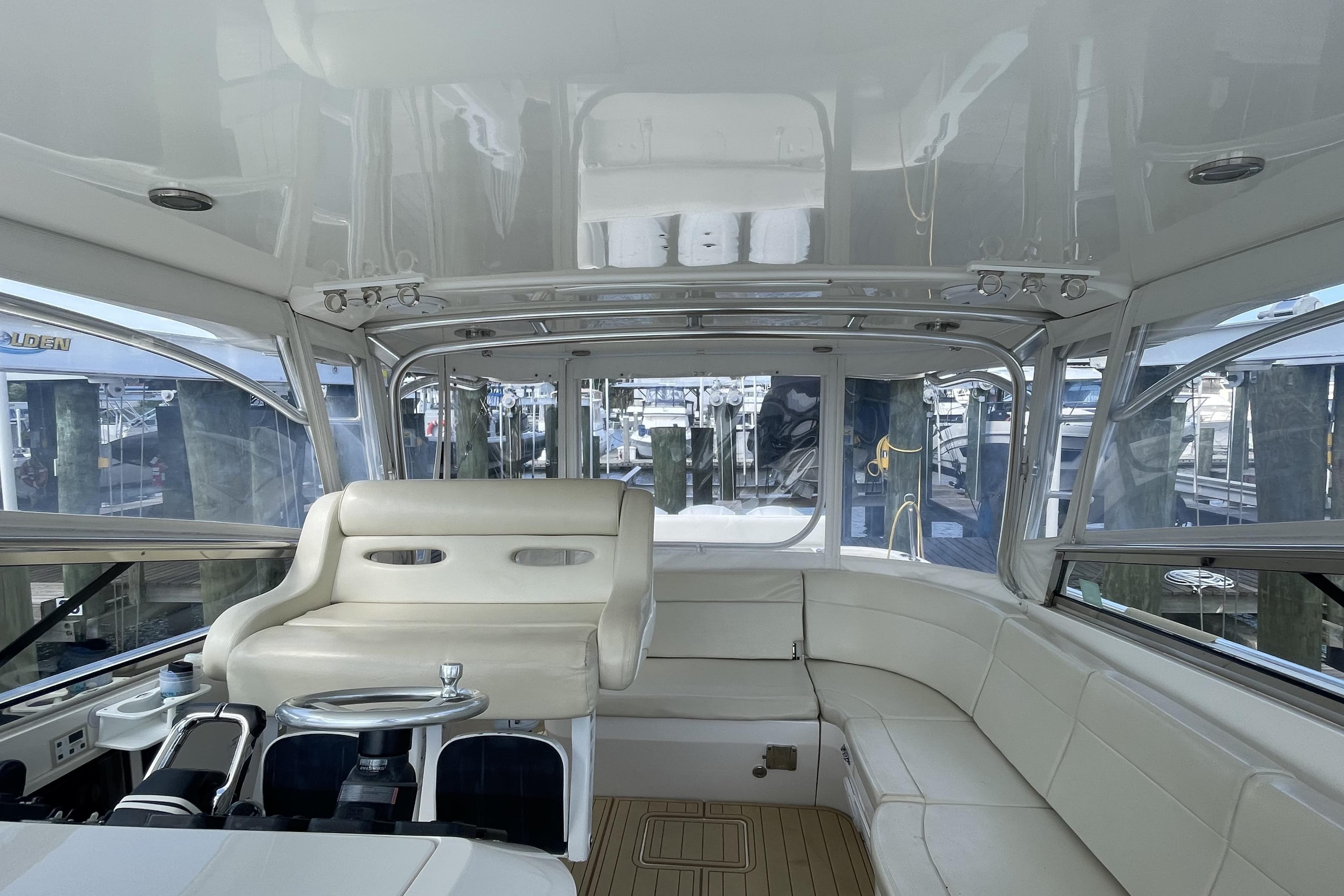 Interior of a 2009 Intrepid 430 Sport Yacht with white seating and helm.