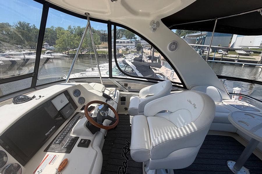 Interior view of 2008 Sea Ray 36 Sedan Bridge yacht cockpit with white seating.