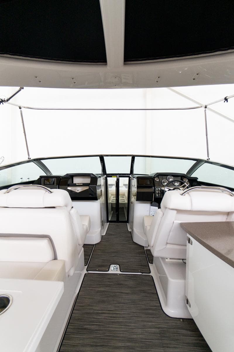 Interior view of 2018 Four Winns 290 Horizon boat, featuring sleek seating and modern dashboard.