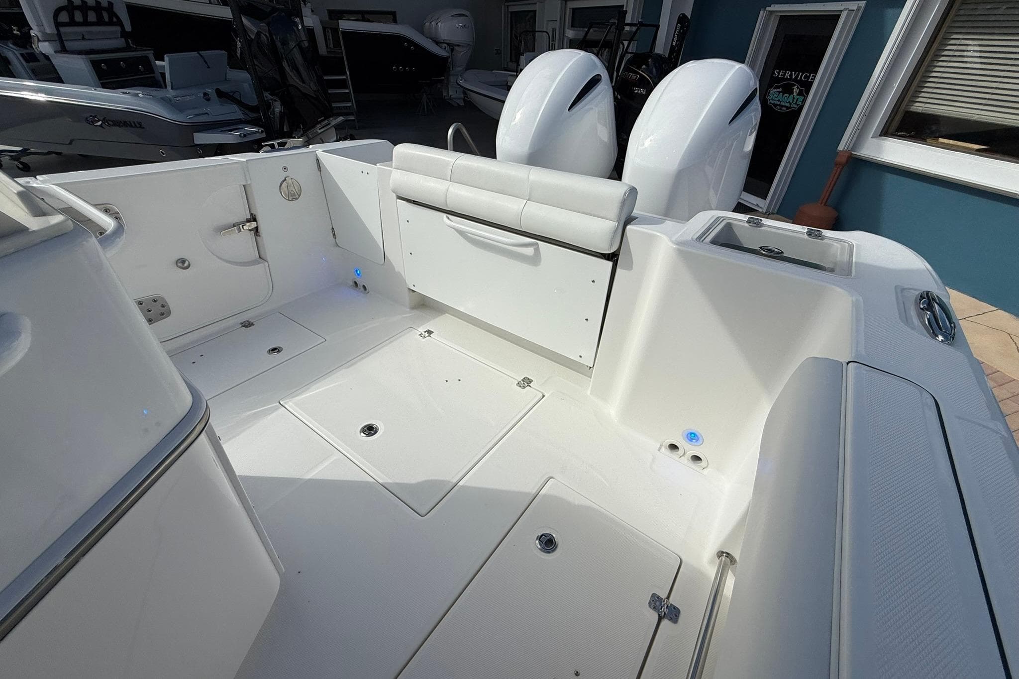 2021 Edgewater 262CC boat interior with dual engines and seating area.