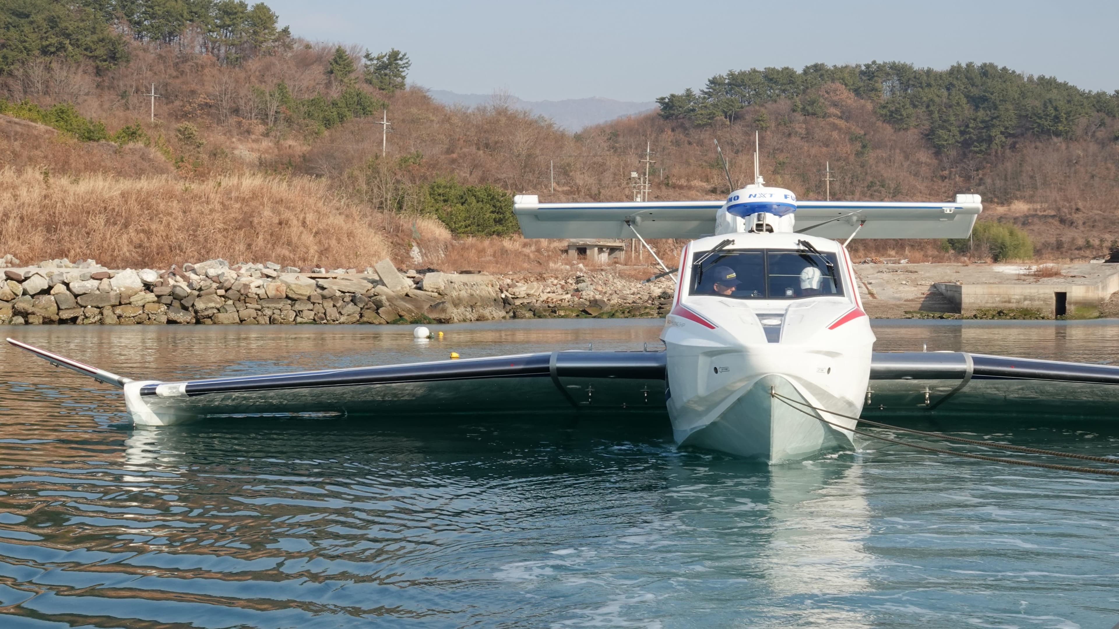 Futuristic Aron M 80 seaplane on water, 2025 model, with scenic background.