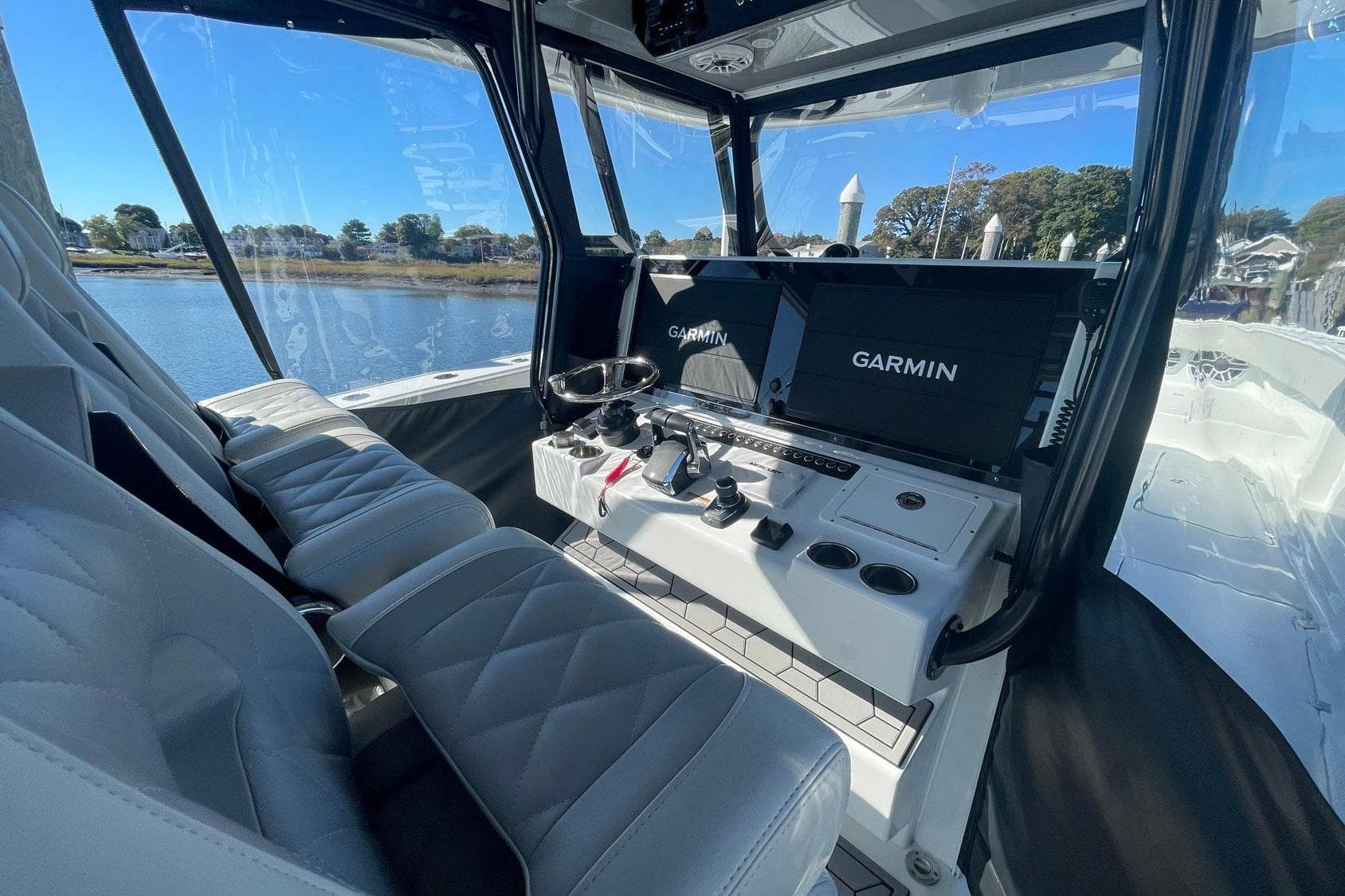 Interior of 2024 Freeman 42LR boat with Garmin navigation system and luxurious seating.
