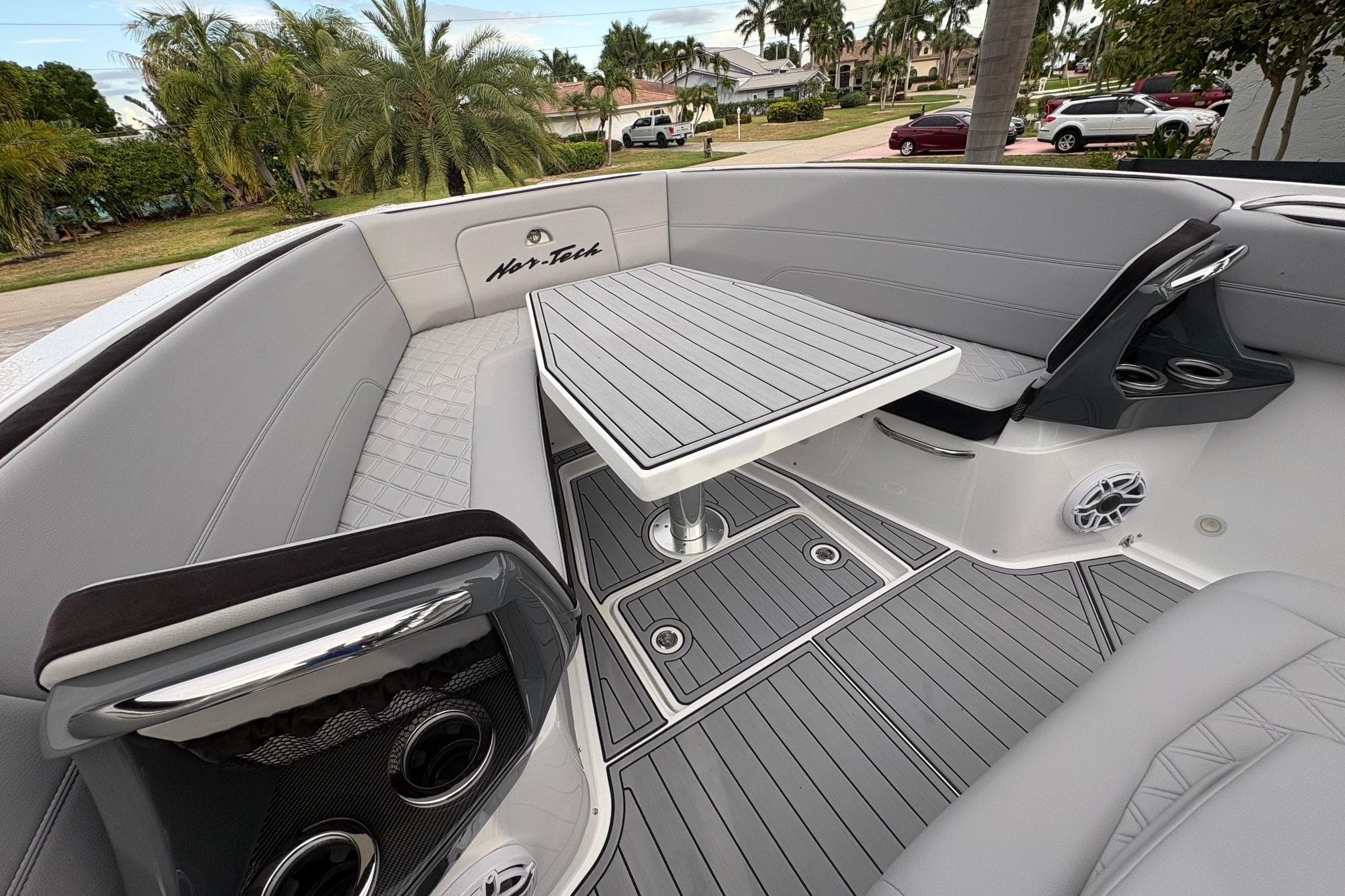 2024 Nor-Tech 390 Sport Center Console interior with sleek seating and modern table design.
