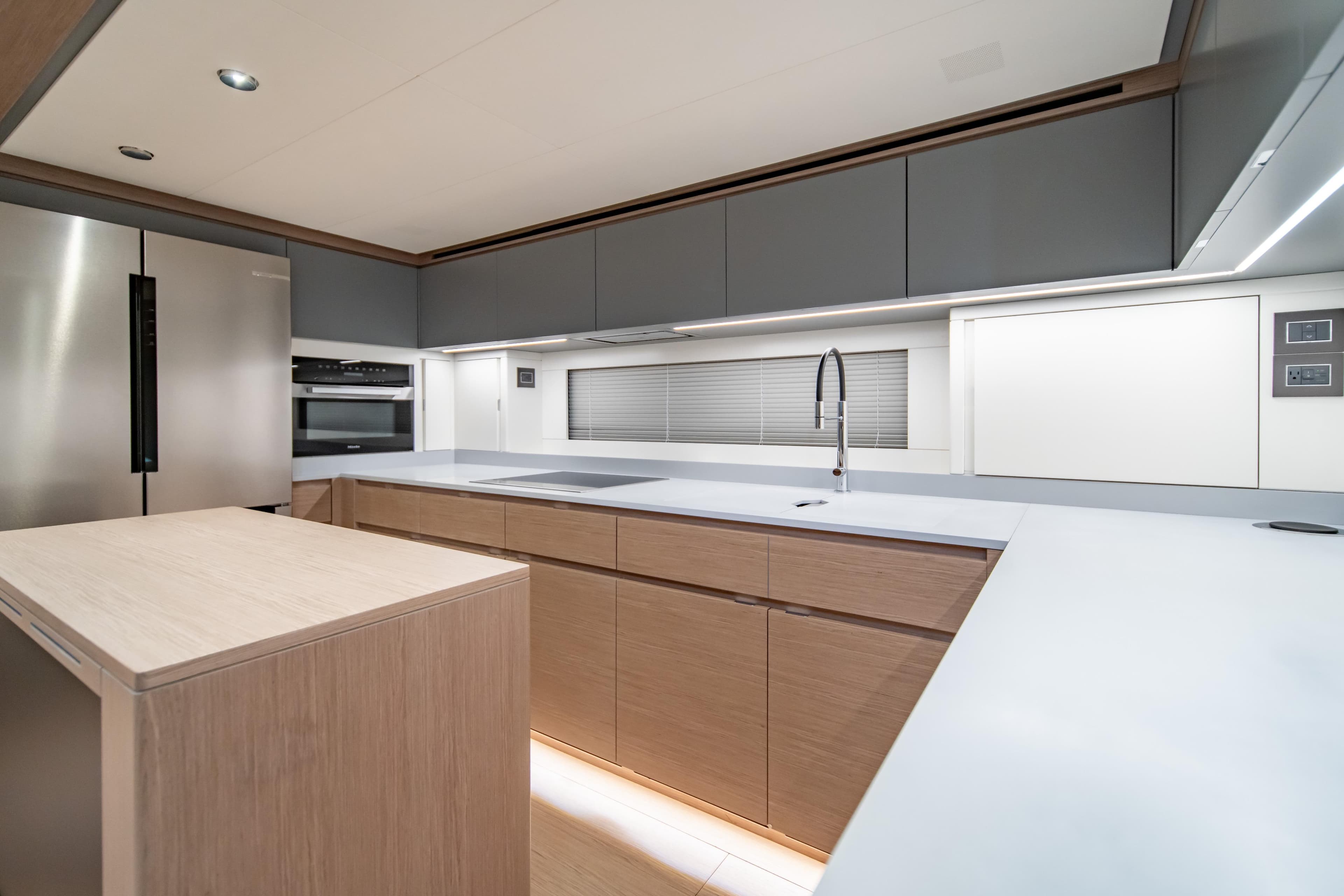 Modern kitchen interior of 2027 Pardo Yachts GT75, featuring sleek cabinetry and stainless steel appliances.