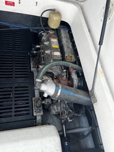 Engine compartment of a 2003 Mainship Pilot 34 boat, showing mechanical components.