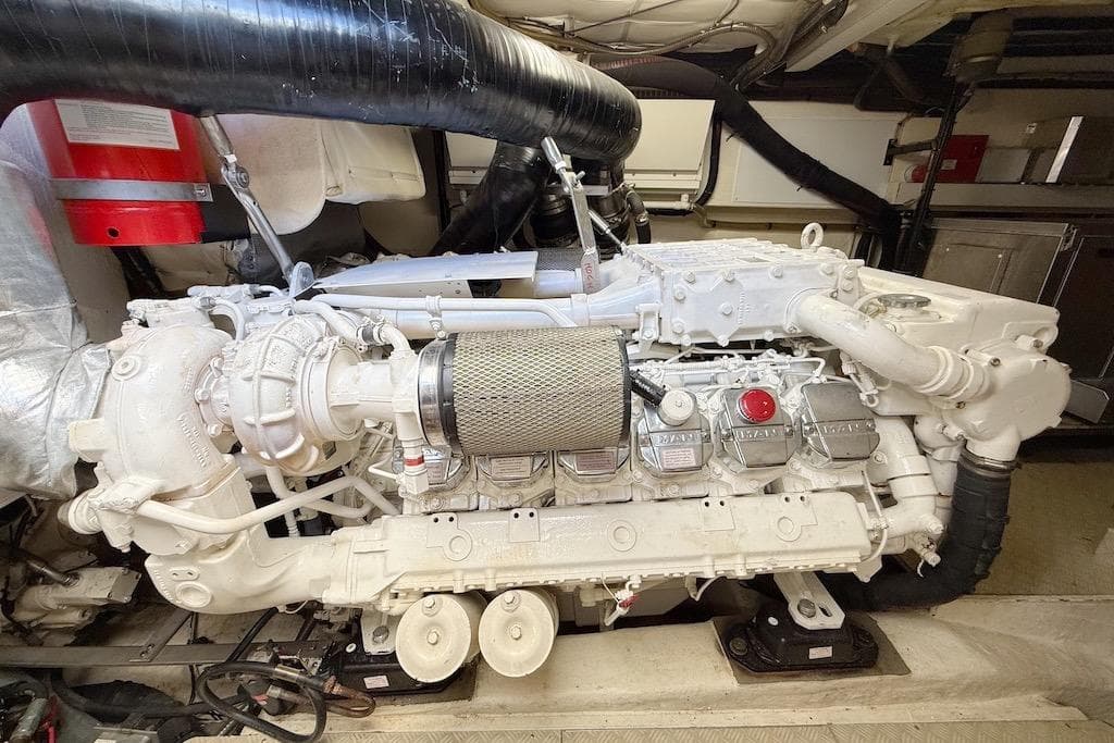 Engine room of 2008 Mochi Craft 64' Dolphin yacht, featuring a powerful marine engine.