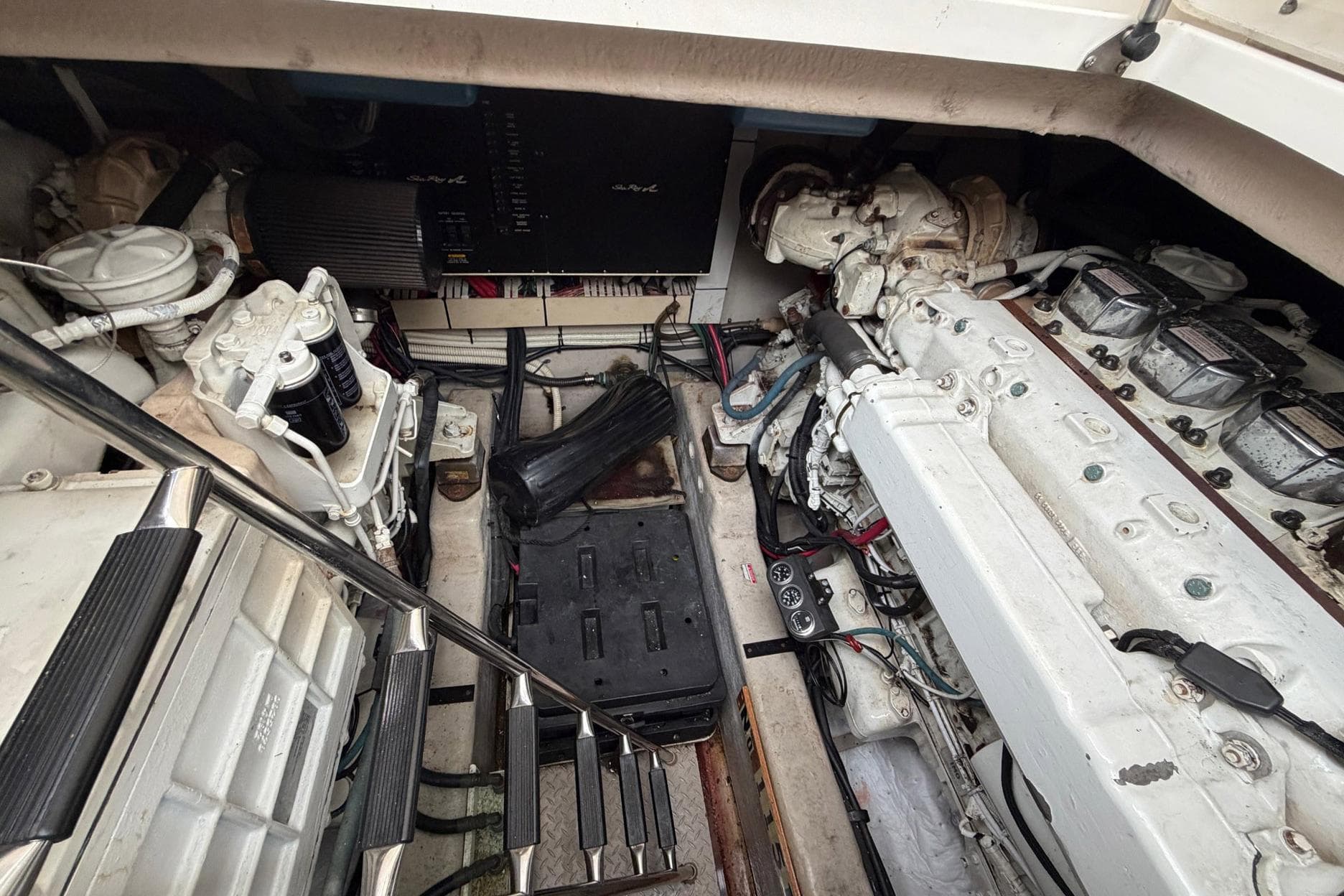 Engine room of a 2004 Sea Ray 500 Sundancer yacht, showcasing mechanical components.