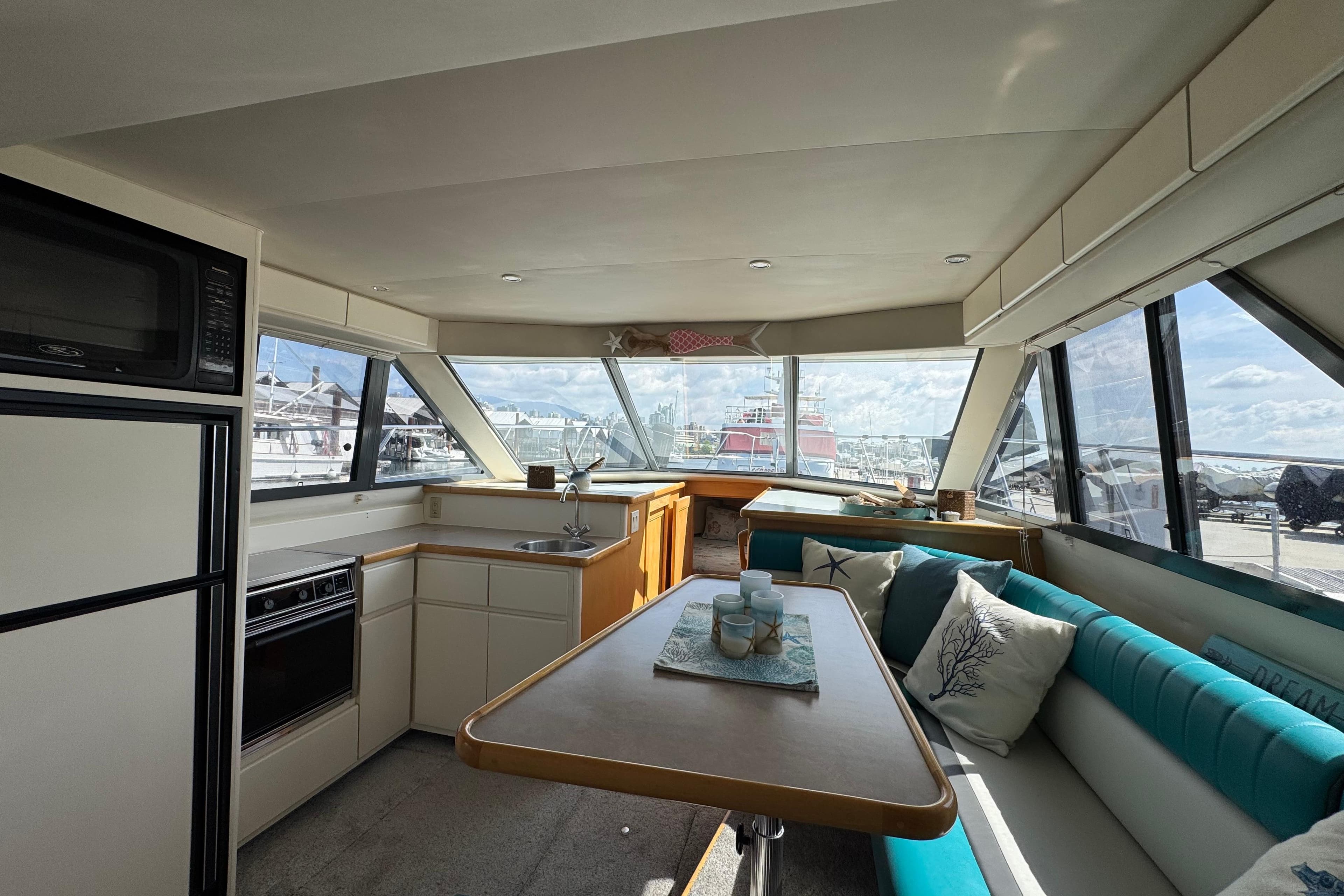 Interior of 1996 Carver 370 Voyager yacht with kitchen and seating area.
