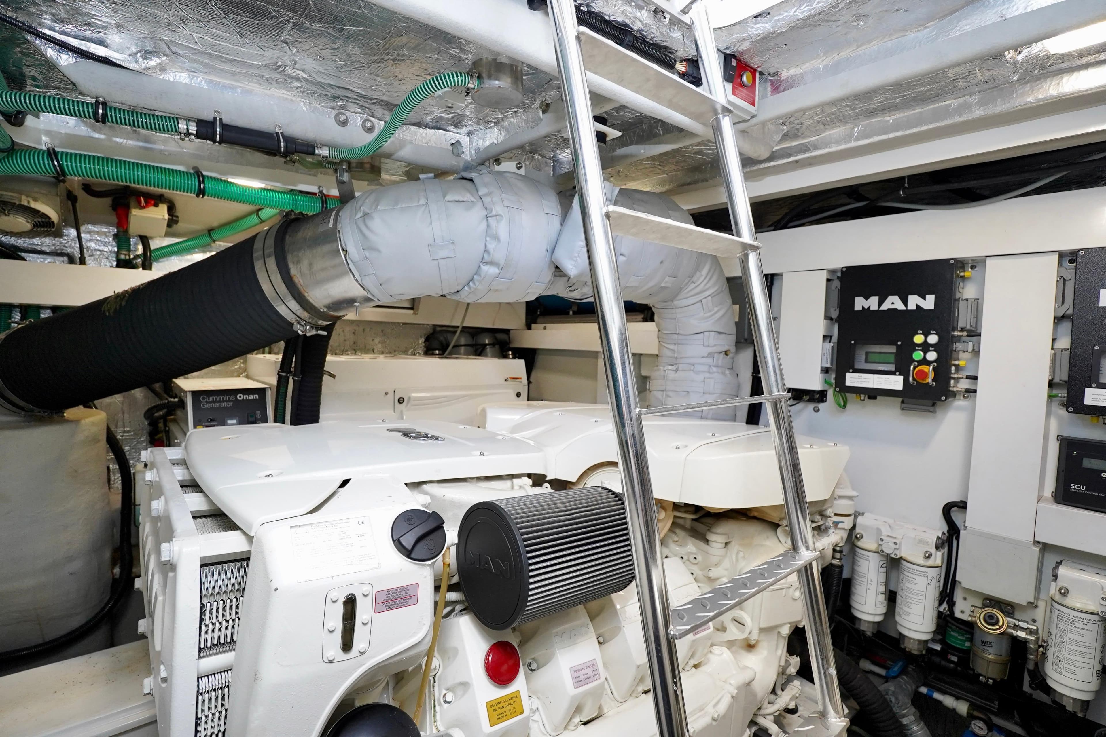 Engine room of 2019 Sunseeker Manhattan 66 yacht with MAN control panel and ladder.