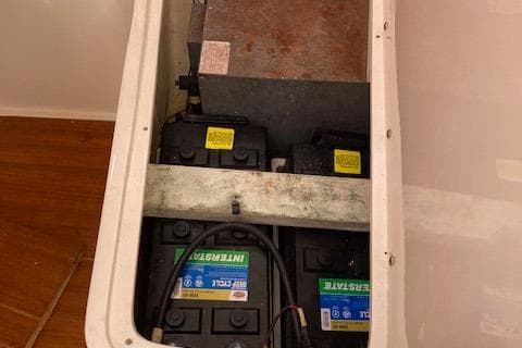 Battery compartment of a 2002 Catalina 34MK II sailboat, featuring dual marine batteries.