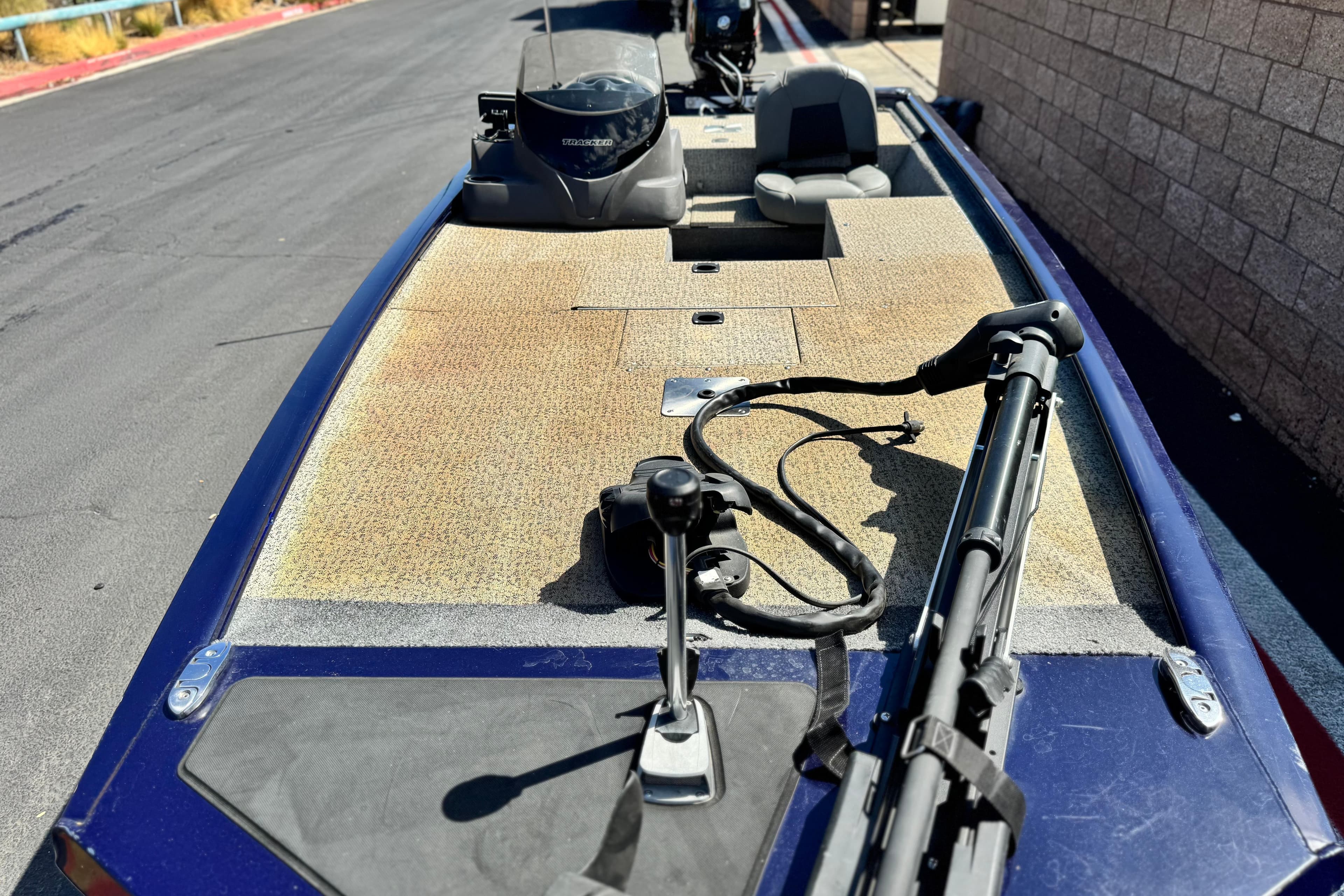 2022 Tracker Pro 170 boat with fishing gear on deck, parked on a paved road.