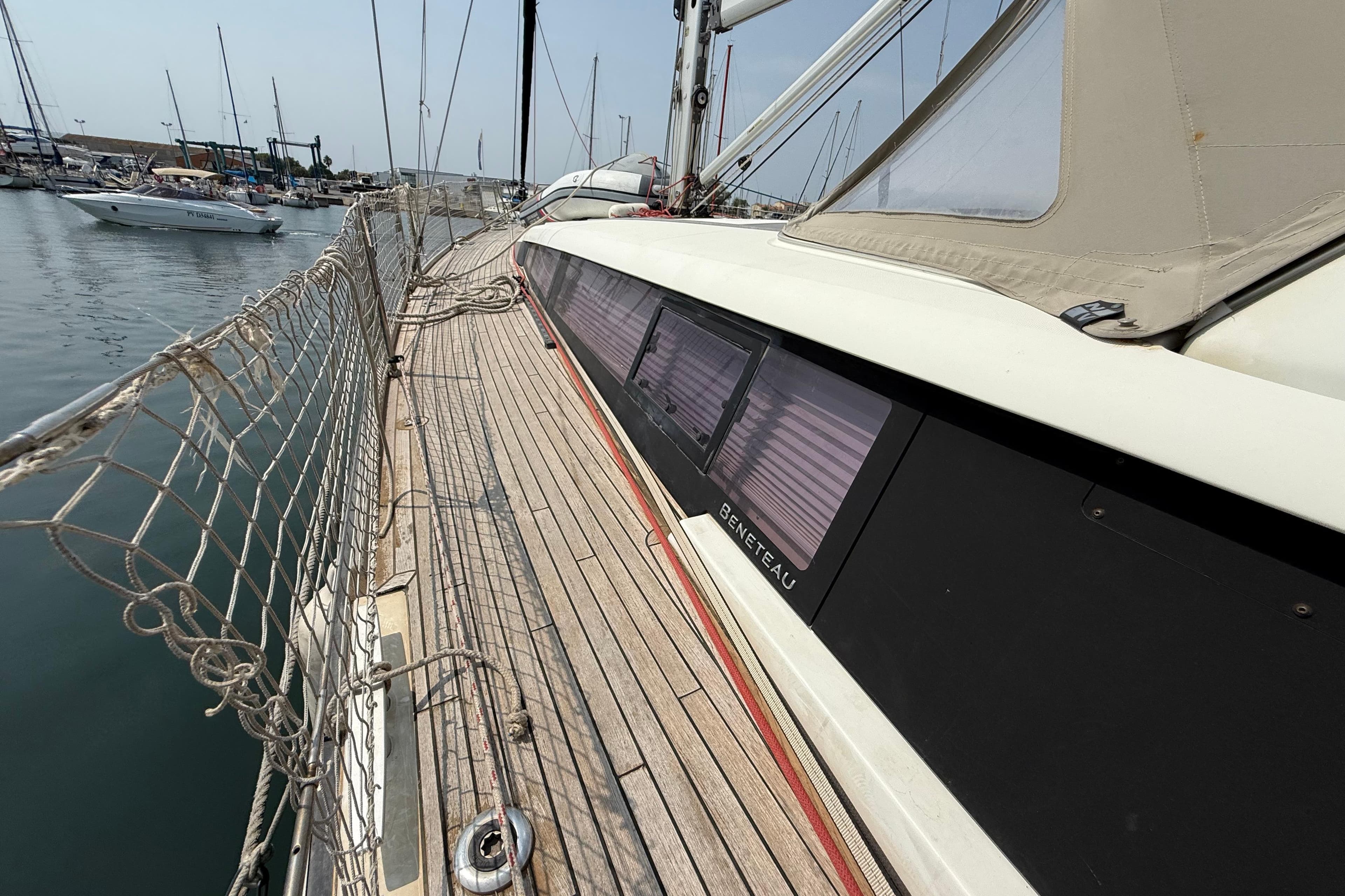 2018 Beneteau Sense 51 yacht docked at marina, showcasing deck and side view.