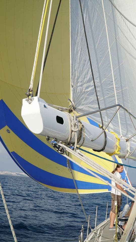 Sailing yacht Devonport Challenge 67, 1995 model, with vibrant yellow and blue sails.