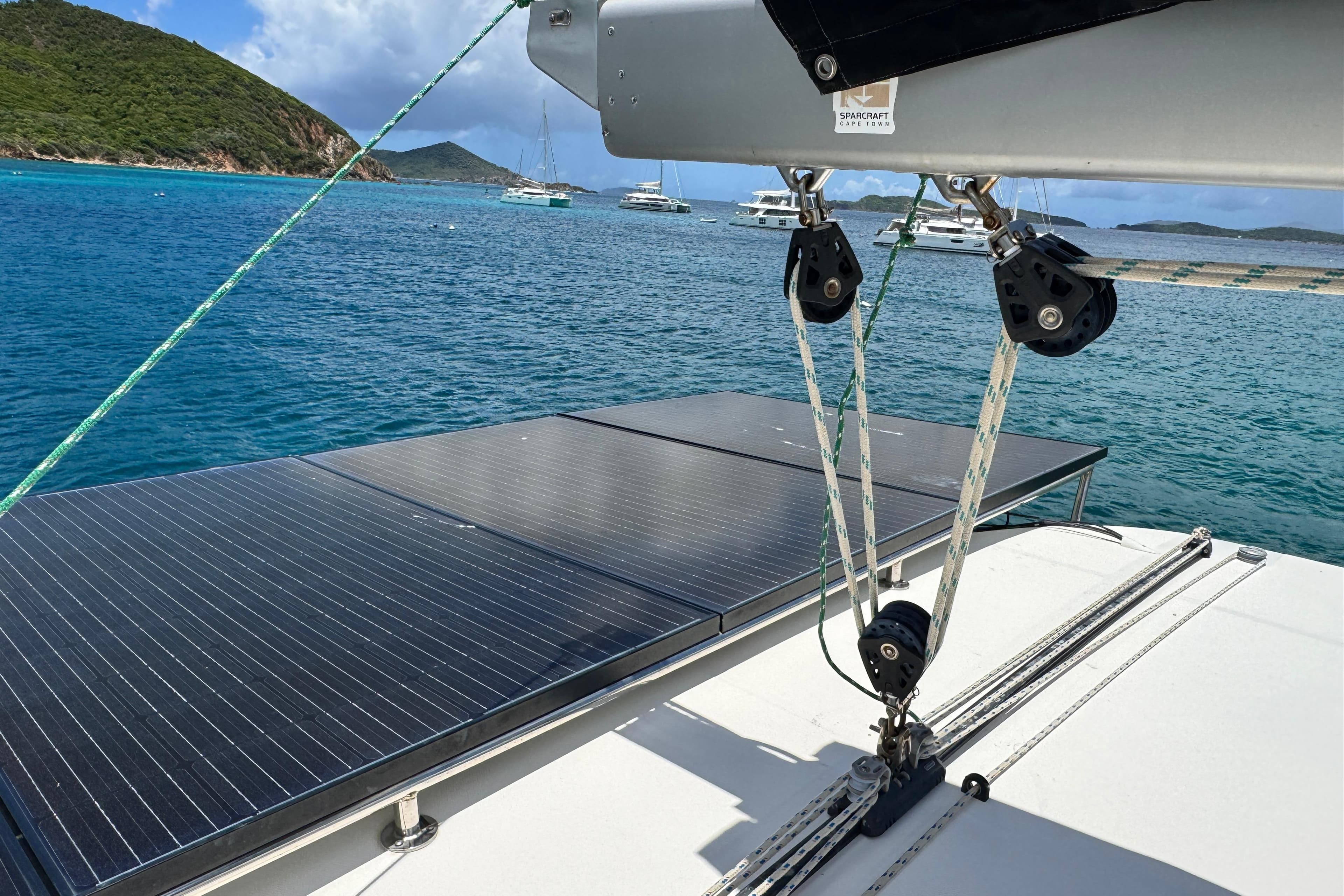 Sailing yacht Leopard 46 (2011) with solar panels, anchored in a scenic bay.