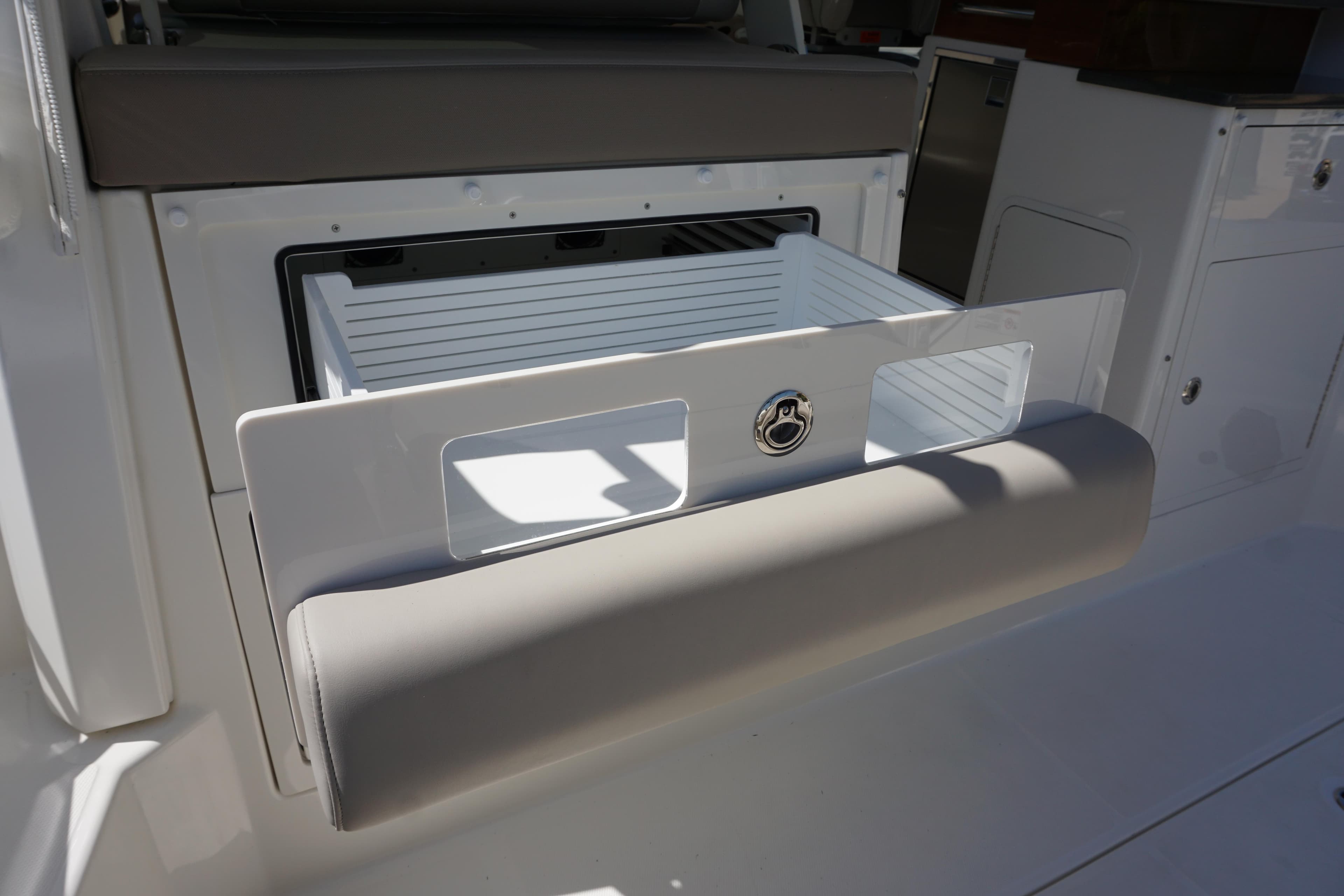 Boston Whaler 365 Conquest 2025 boat storage compartment with cushioned seating.