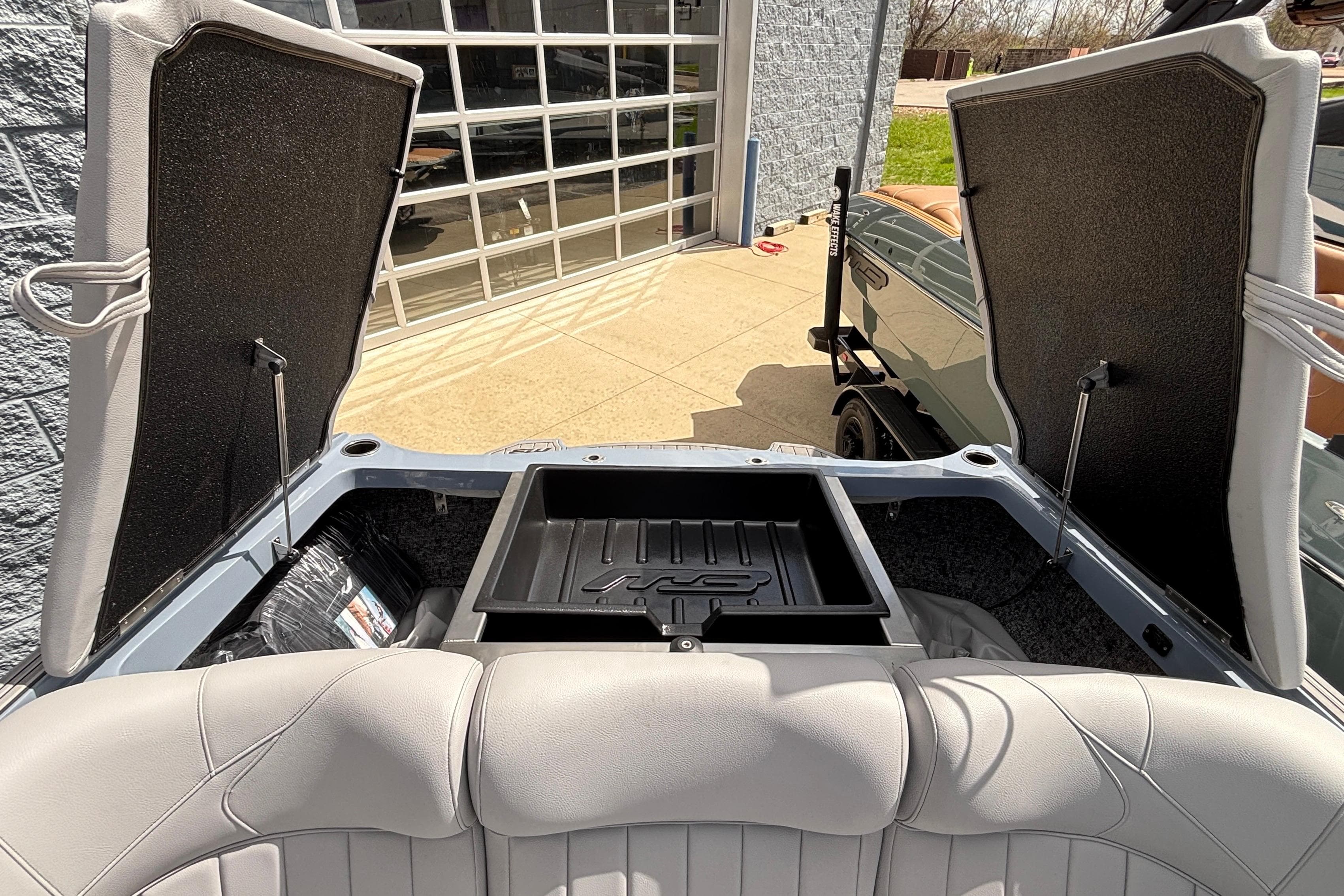 2026 MB B52 23 Classic boat interior with open storage compartments and cushioned seating.