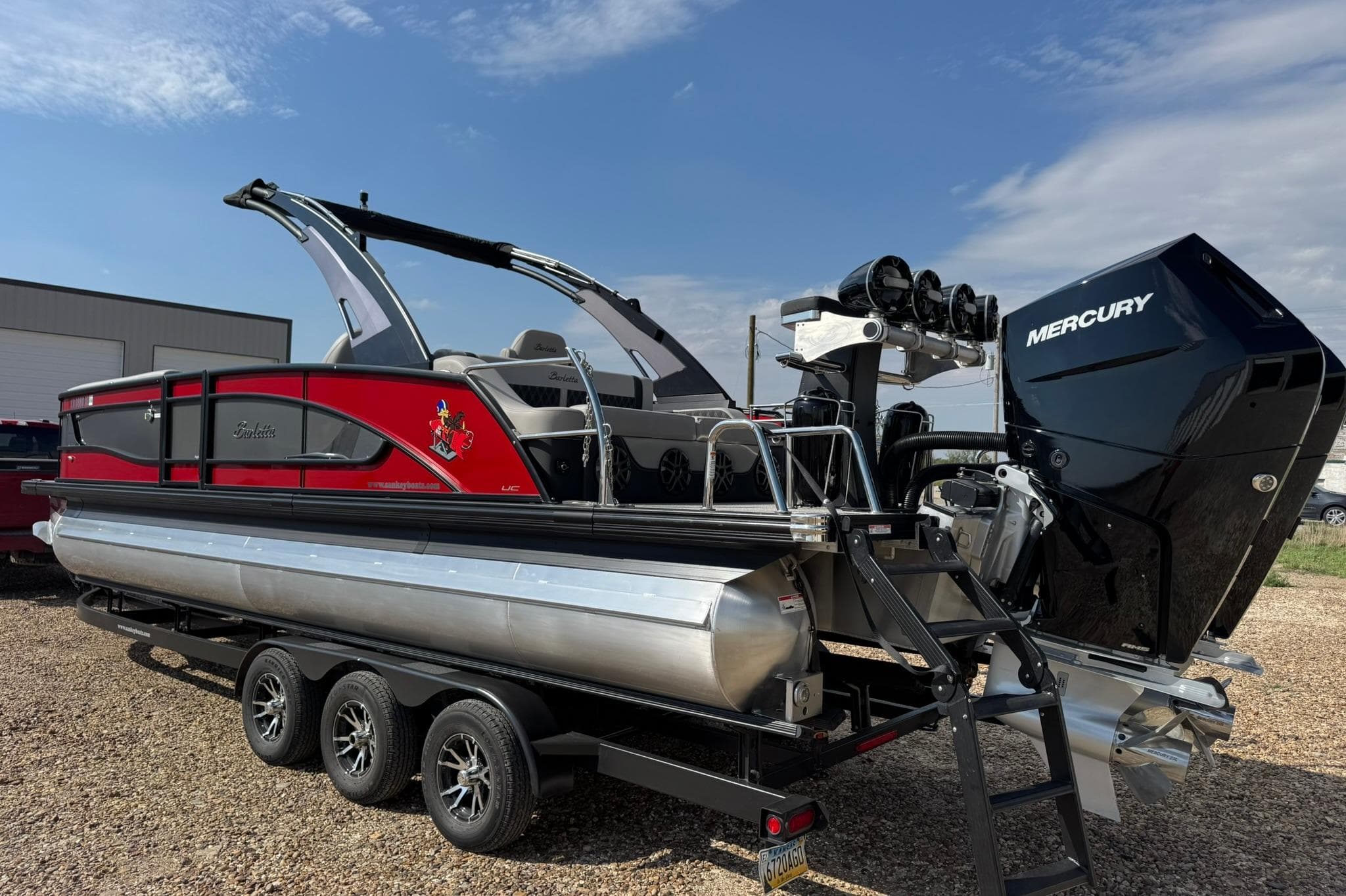 2025 Barletta LUSSO 25UCAT pontoon boat with Mercury engine on a trailer.