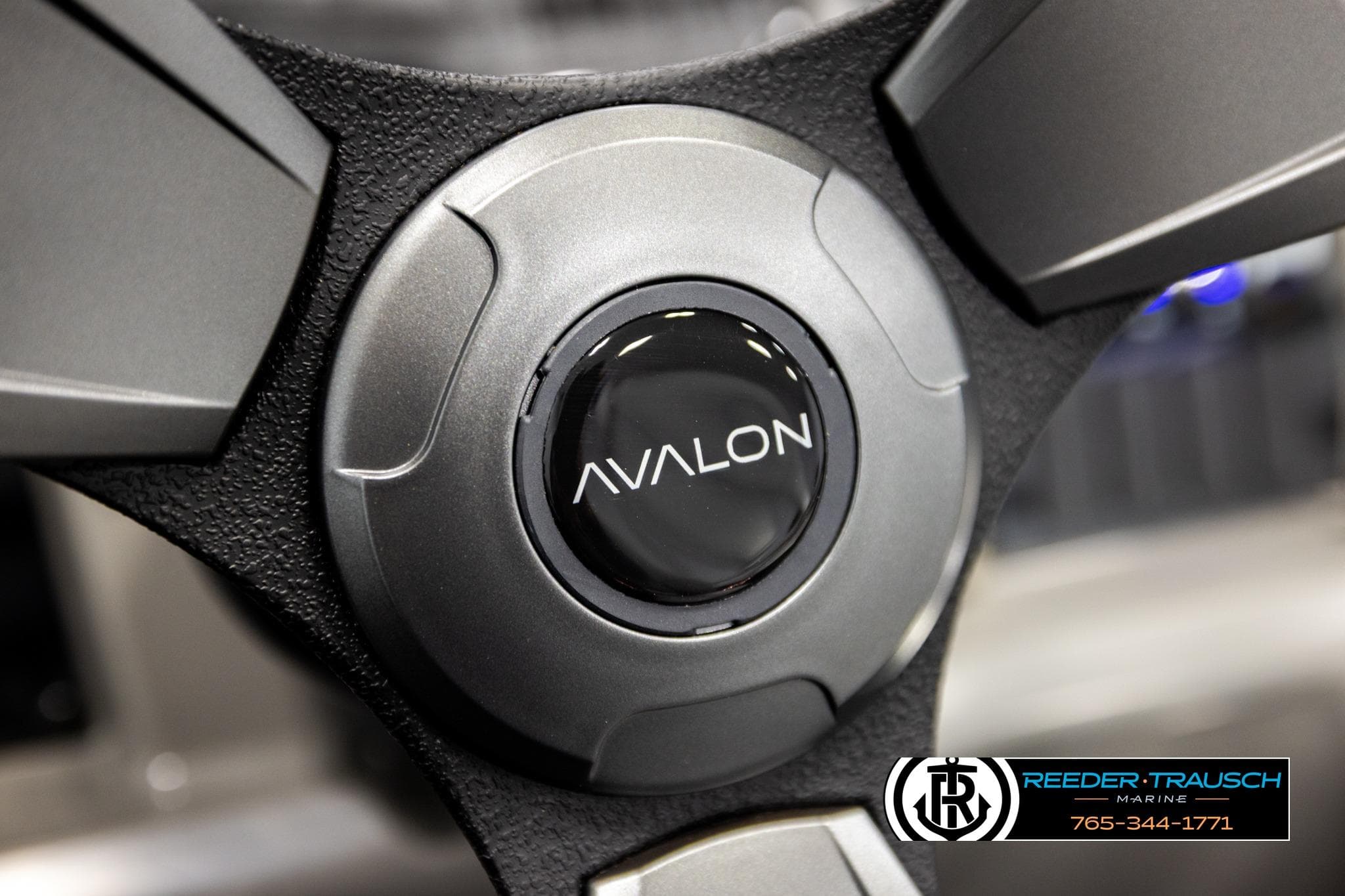 Steering wheel of 2026 Avalon VEN RF boat, featuring sleek design and logo.