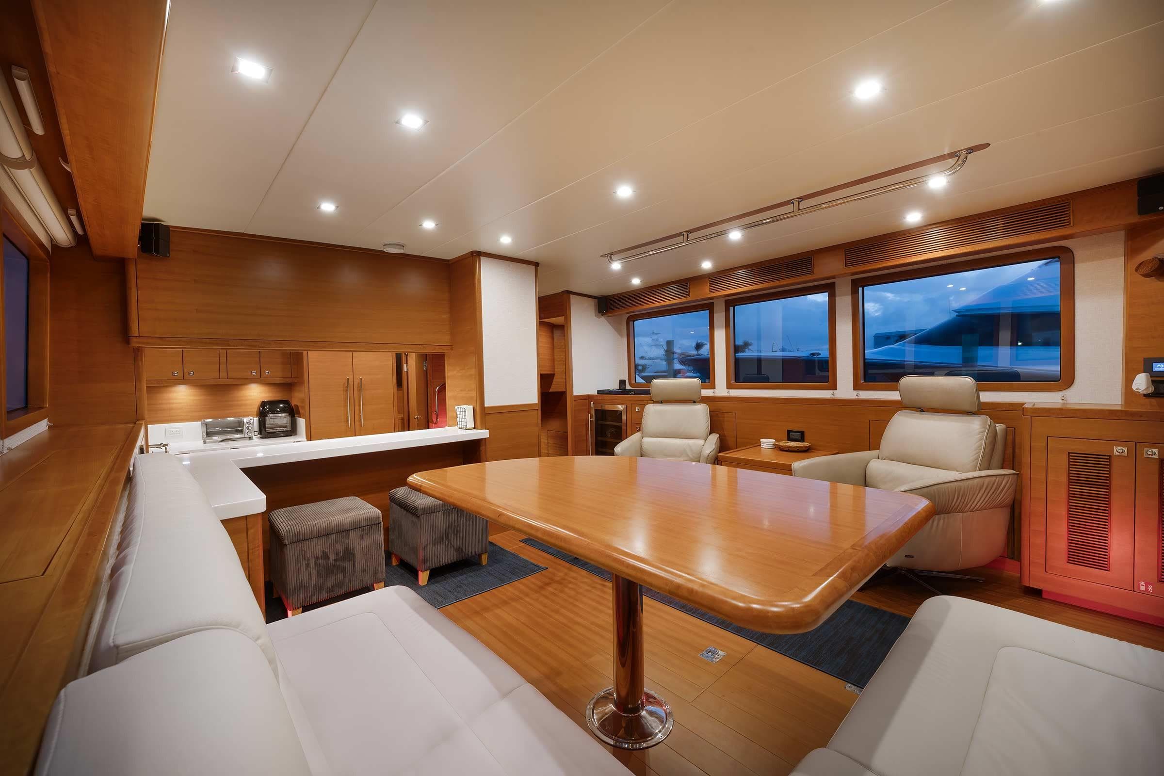 Luxurious interior of 2025 Nordhavn 625 yacht with modern seating and wooden finishes.