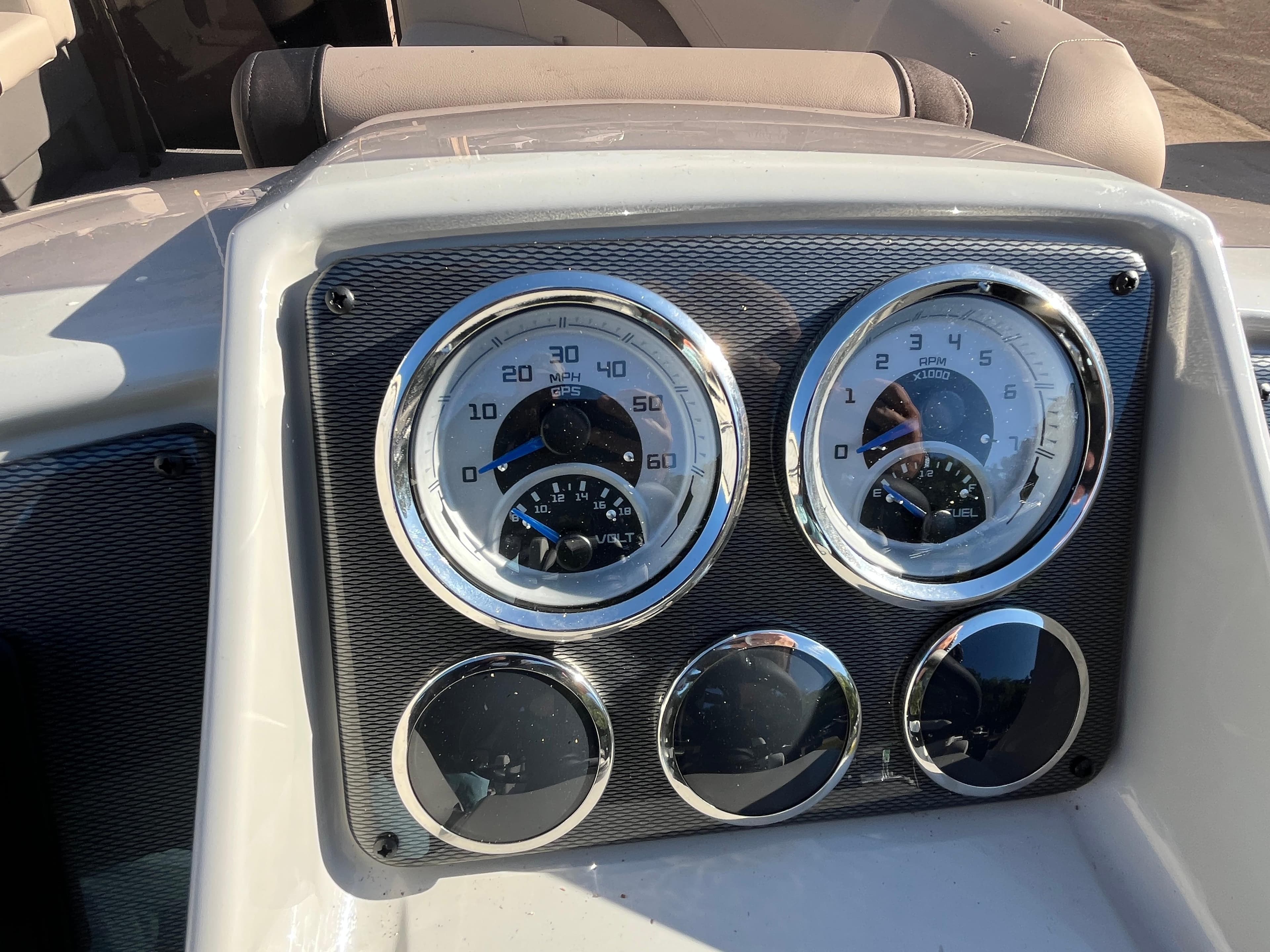 Dashboard of 2025 Starcraft EXS-3 boat with speedometer and fuel gauges.