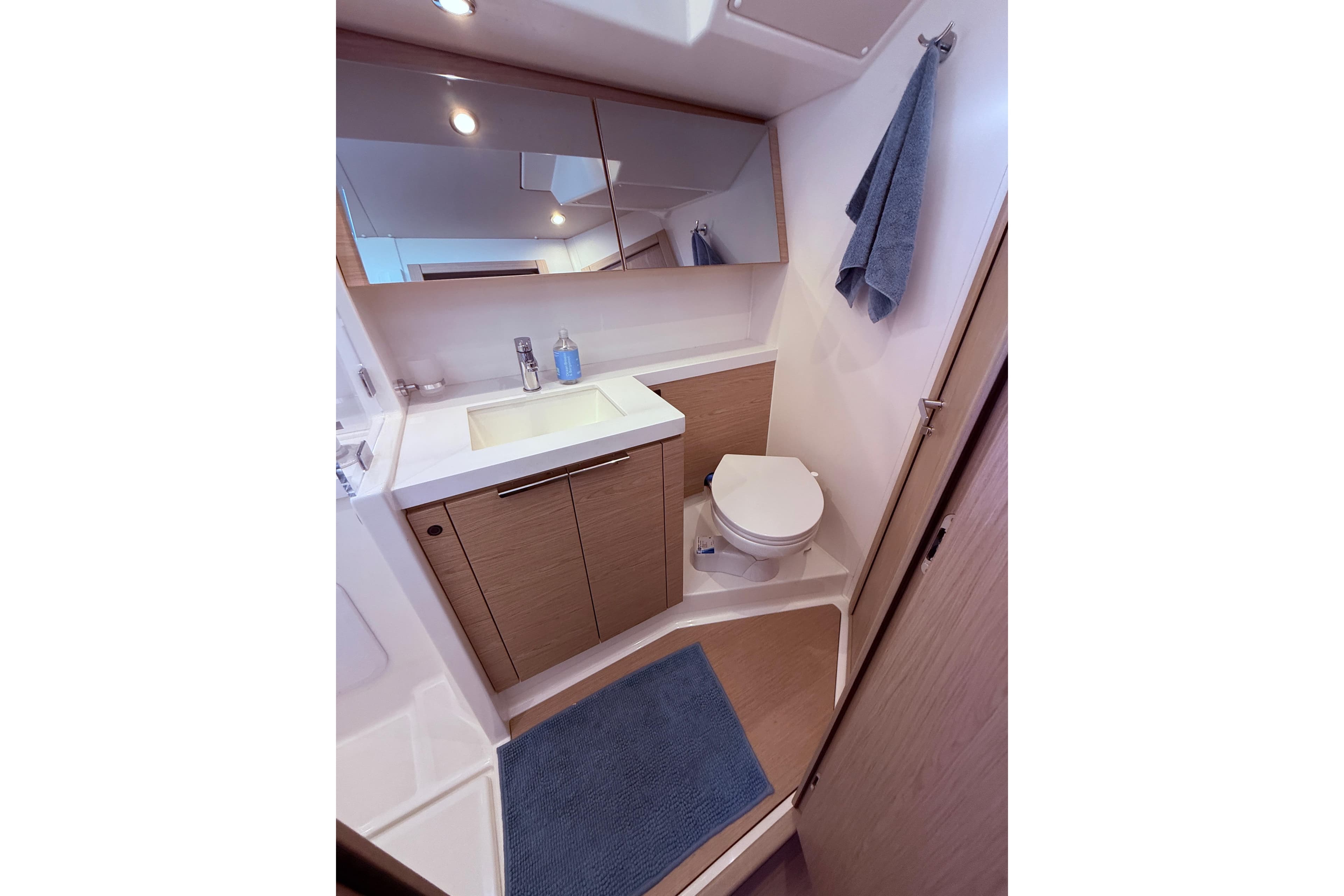 Modern bathroom in 2022 Beneteau Oceanis Yacht 54, featuring sleek design and amenities.