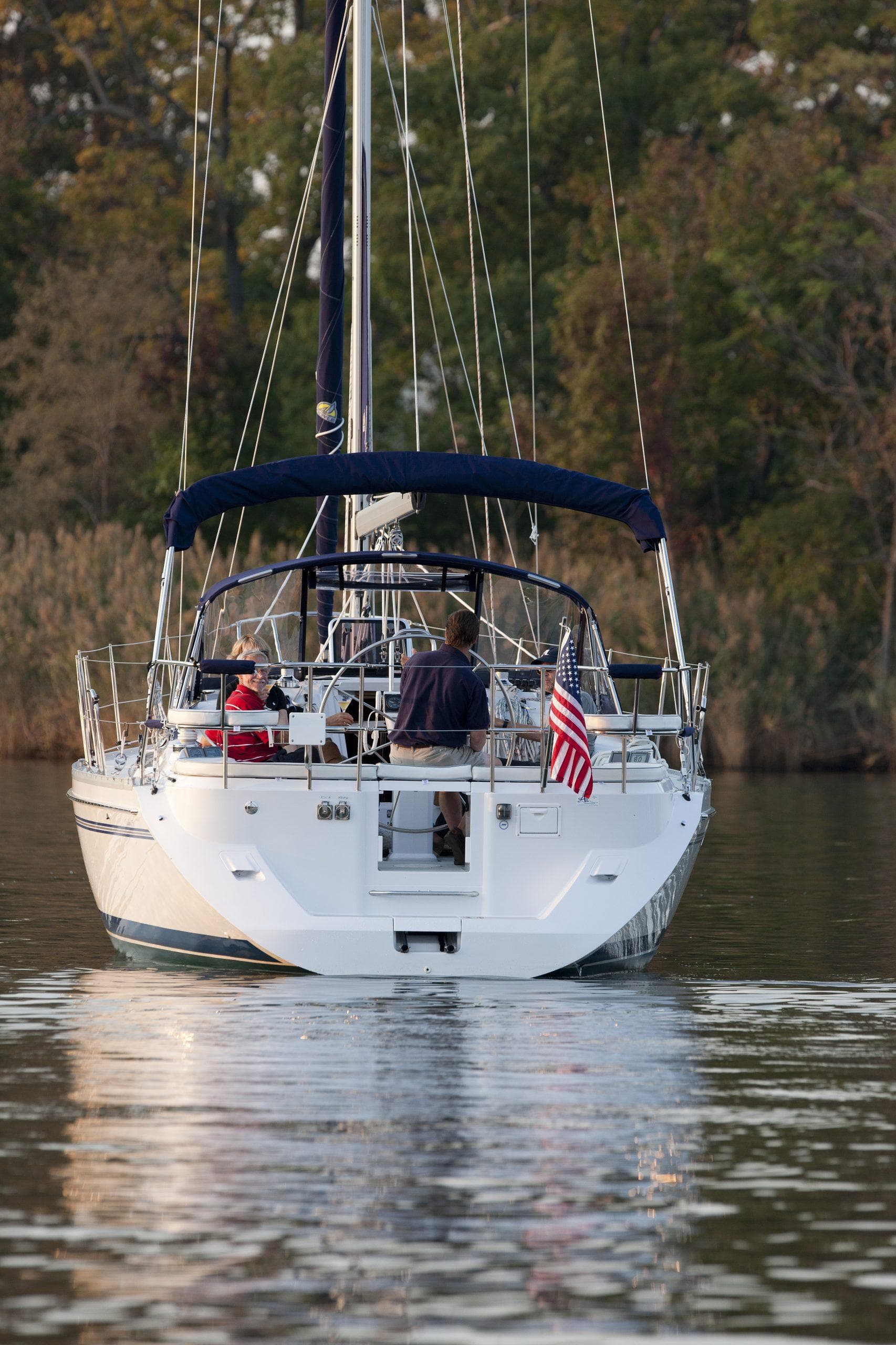 2024 Catalina 355 sailboat cruising on a calm lake with passengers.