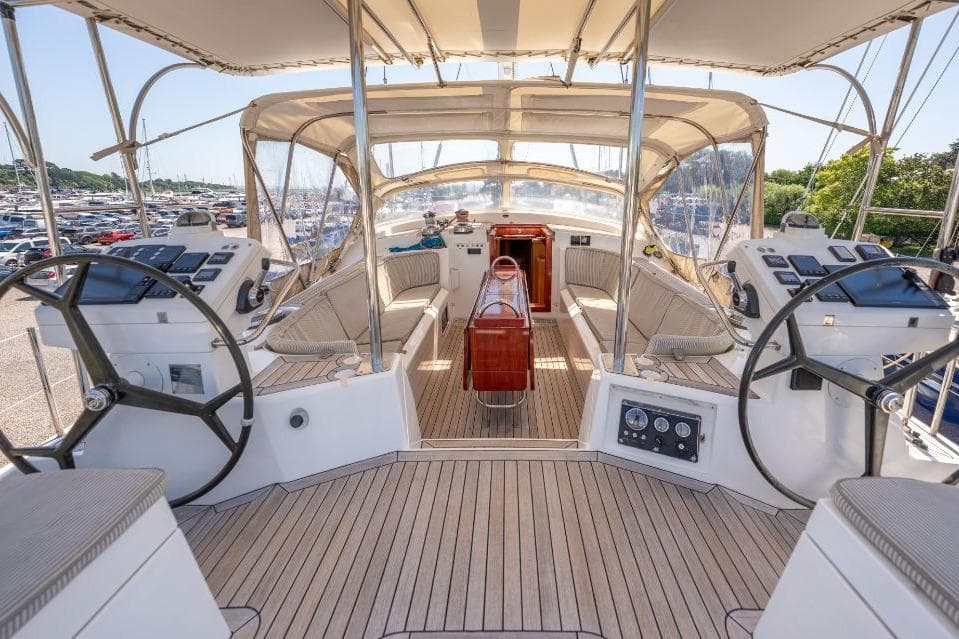 Luxurious 2011 Discovery 67 yacht cockpit with dual steering wheels and elegant seating.