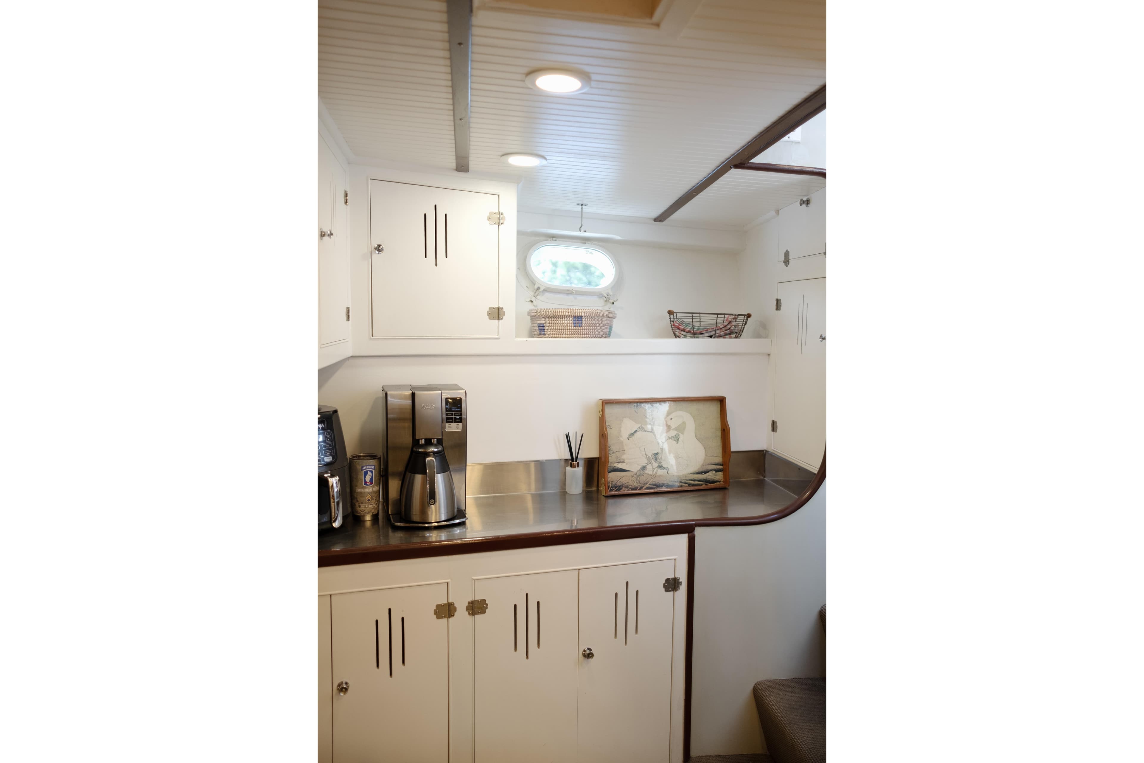 Vintage 1954 Grebe Sedan interior with white cabinets and coffee maker.