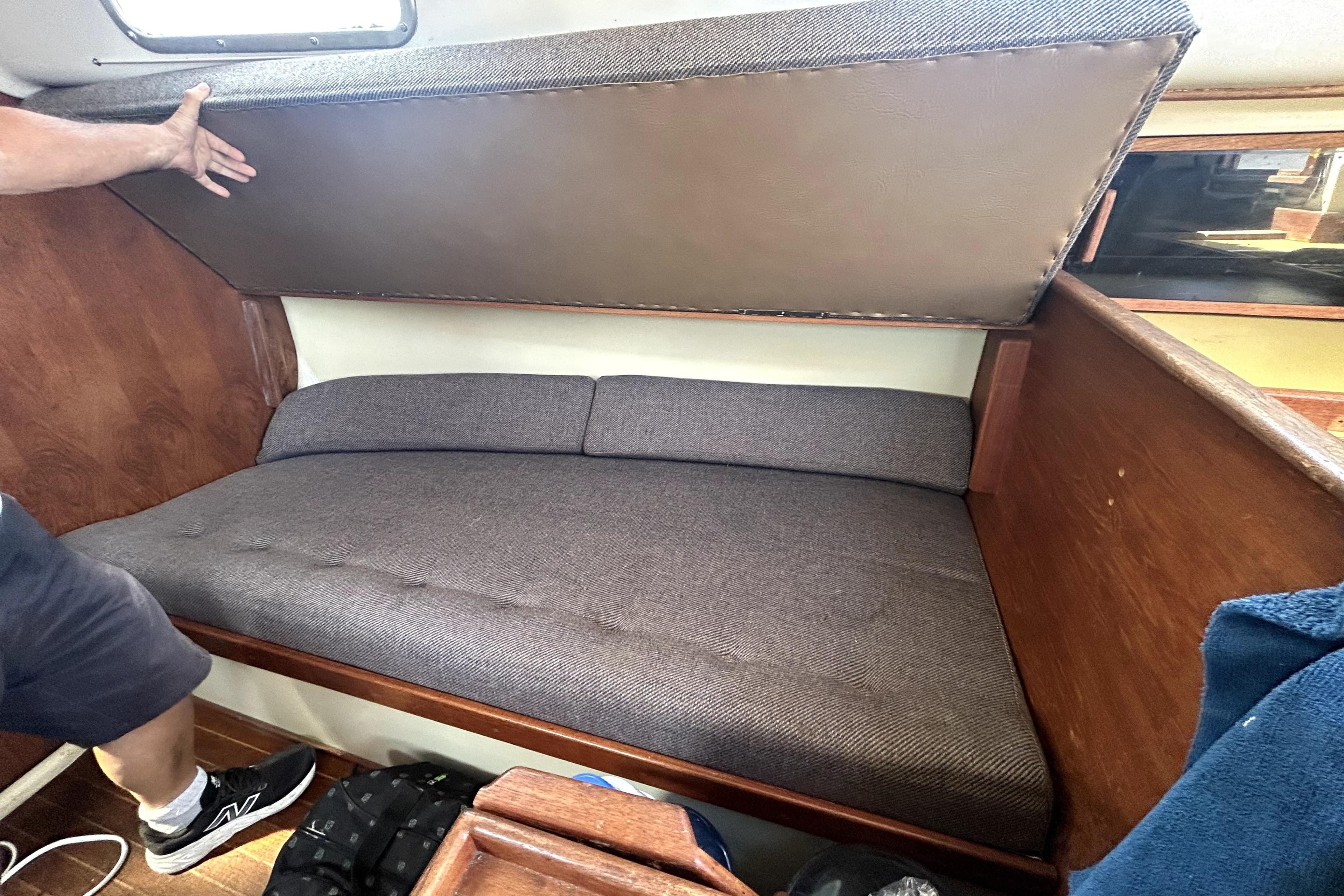 Interior cabin of a 1981 Bayfield 32 sailboat with a foldable bunk bed.