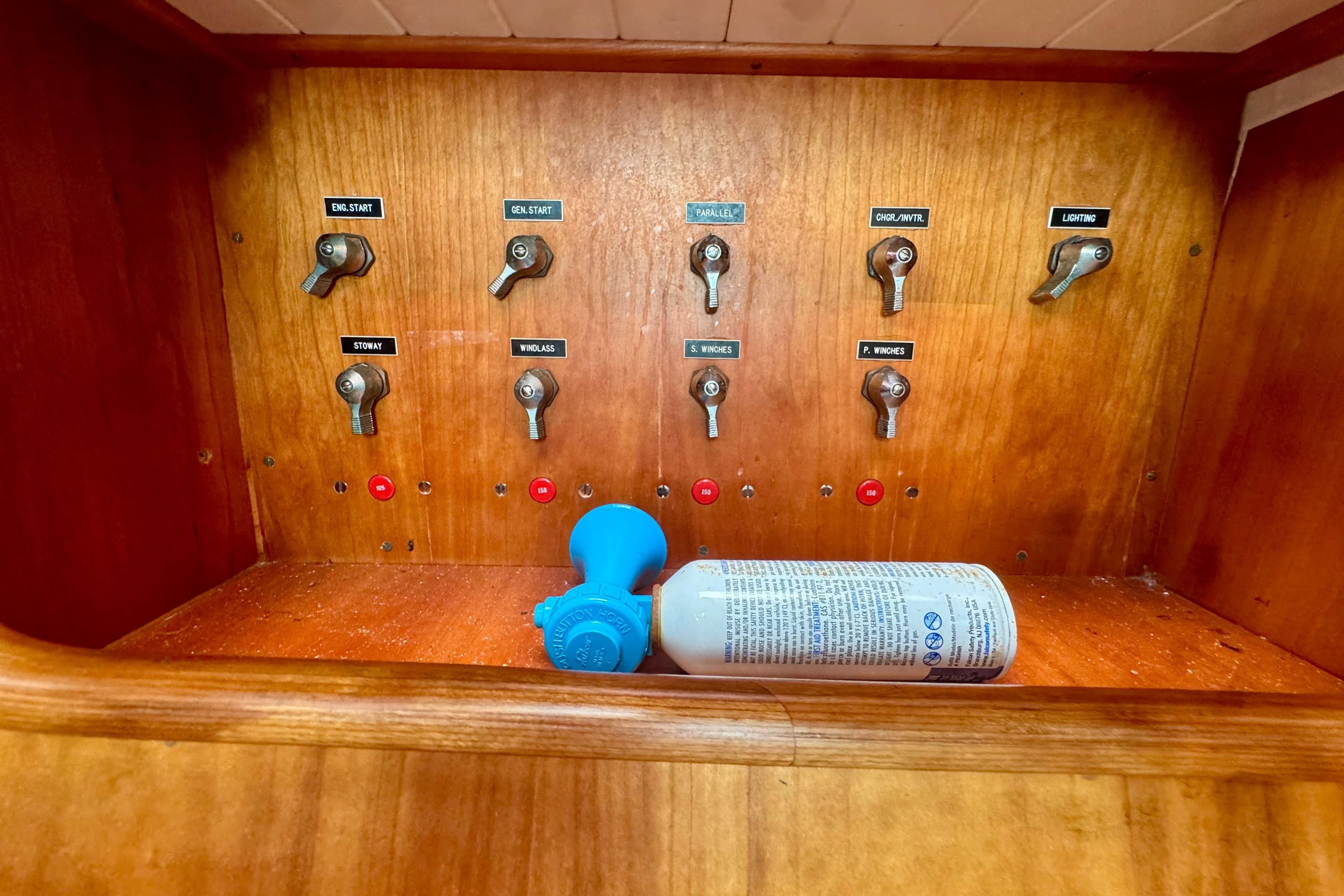 Control panel of 1999 Hinckley Sou'wester 52 sailboat with switches and air horn.
