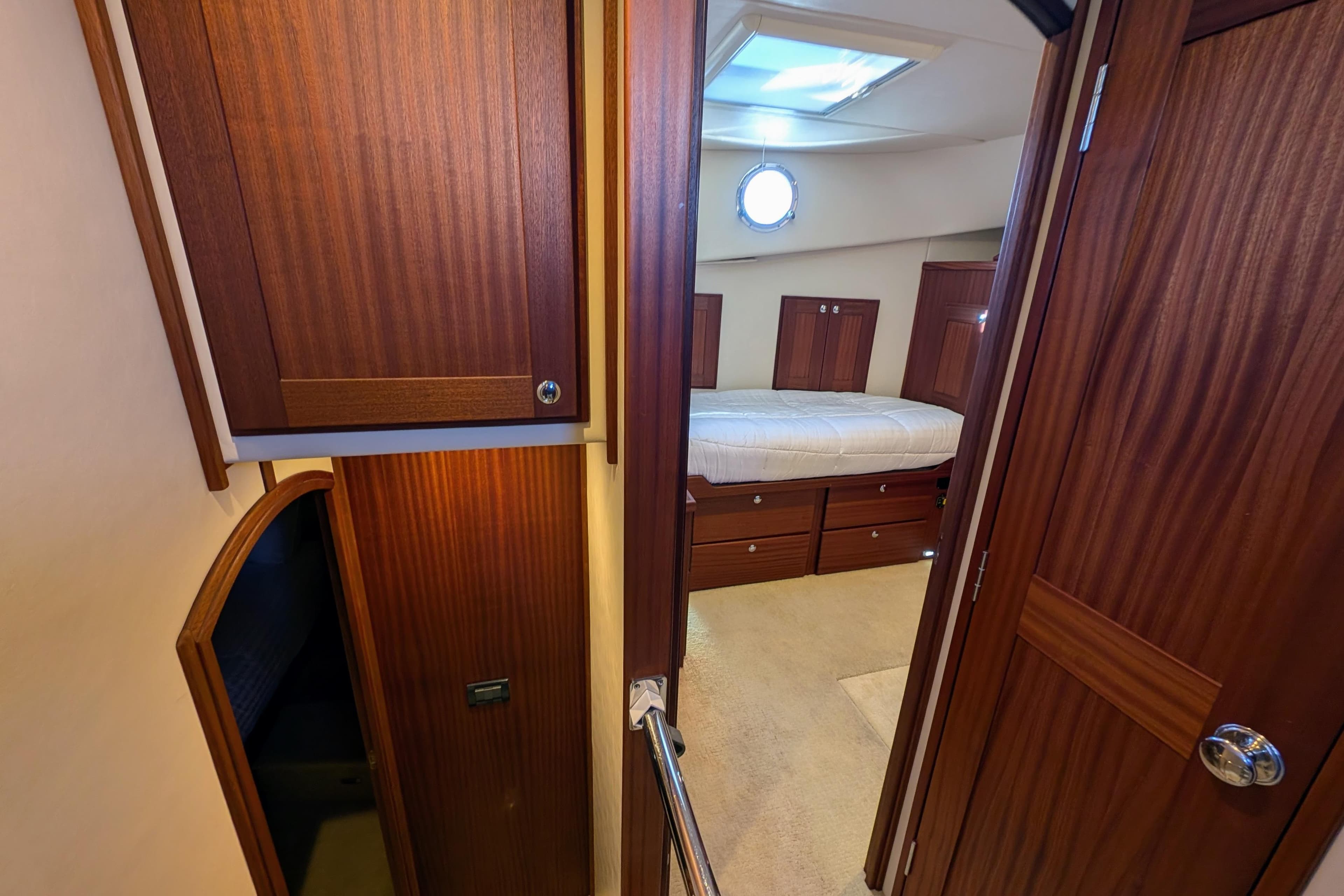 Interior cabin of 2015 American Tug 435 with wood paneling and bed.