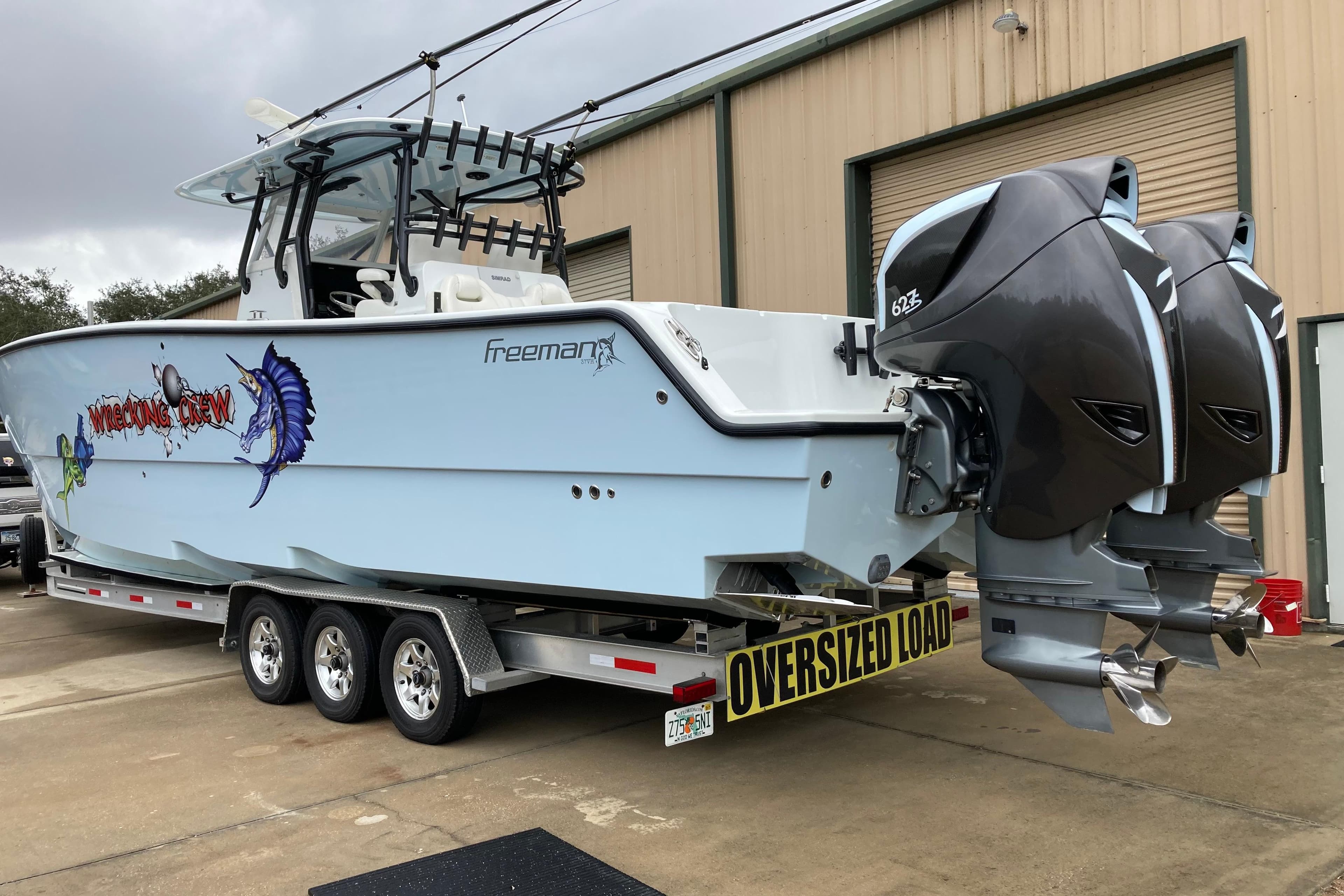 Freeman 37VH 2016 boat on trailer with twin engines, labeled "Wrecking Crew."