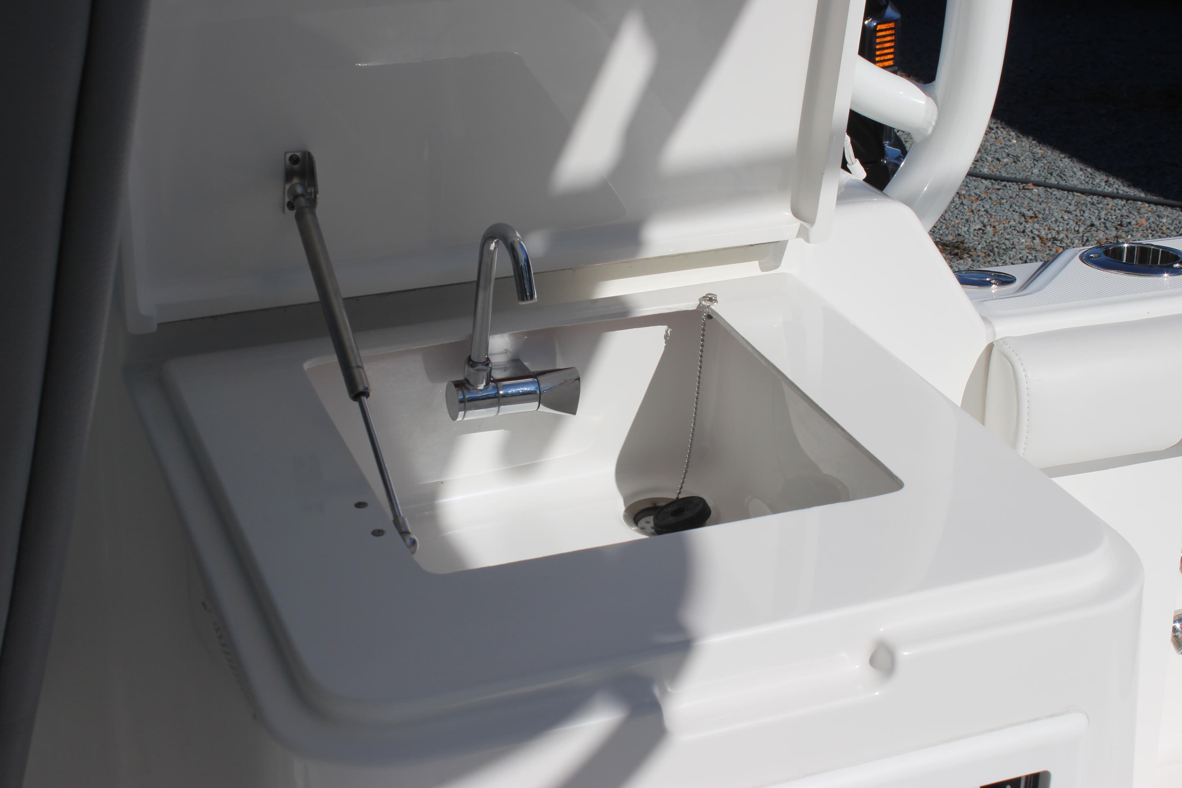 2022 Albemarle 27 DC boat sink with faucet and cover.